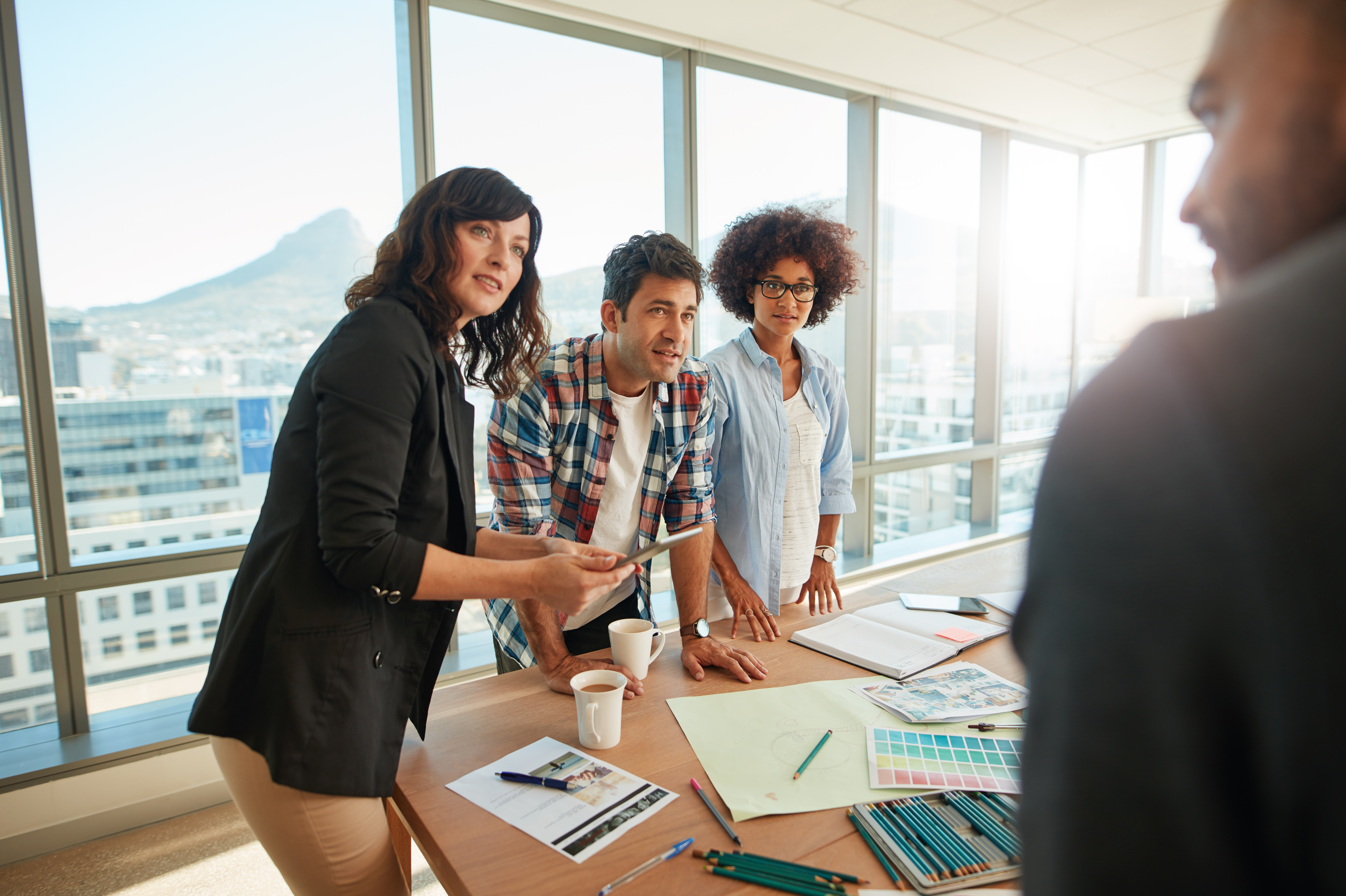 team brainstorming over new designs in office dee0f774483f8d2686f1