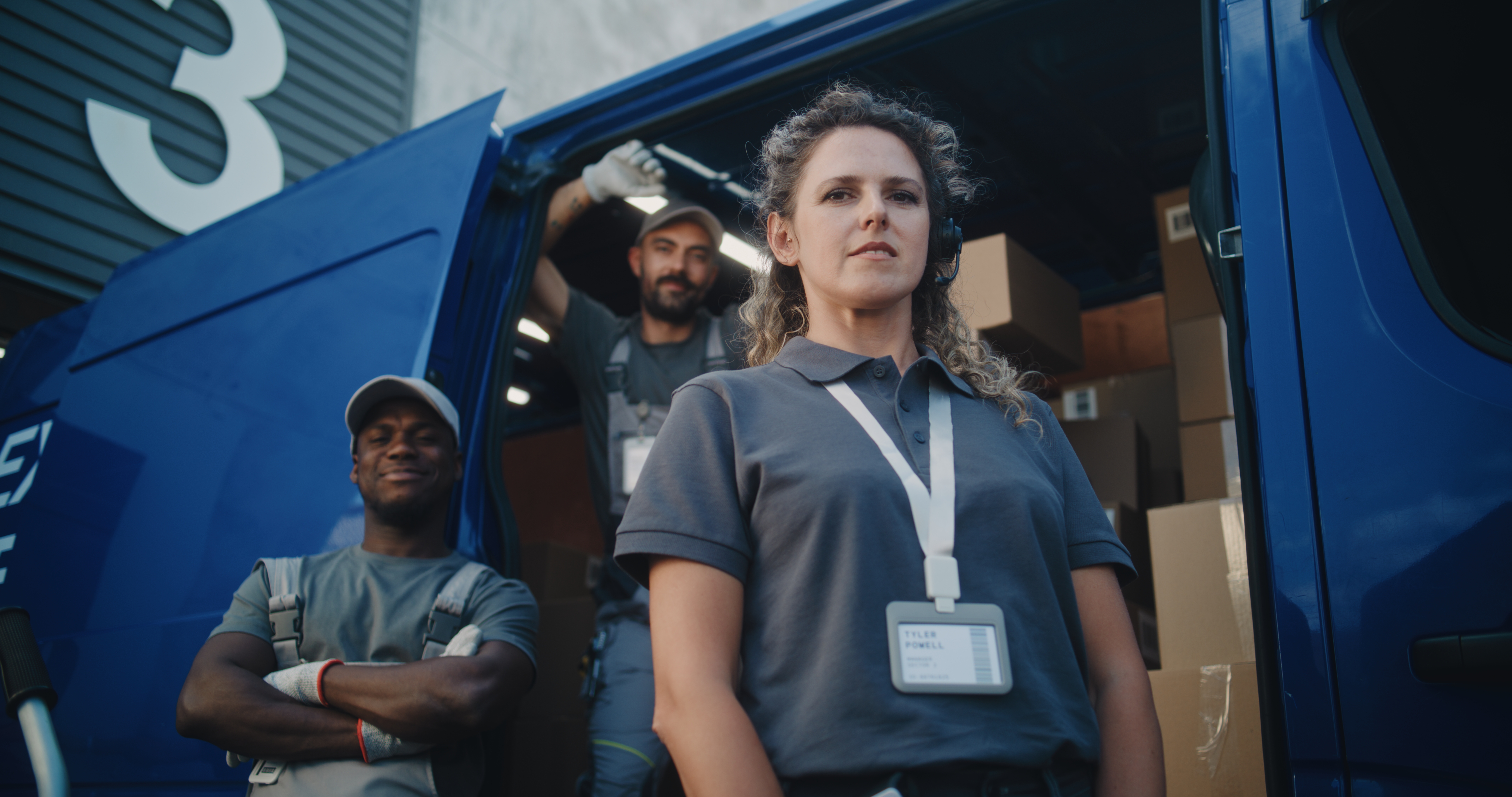 team of diverse workers standing outside of logist 16a8eb1a9885632ad6e9