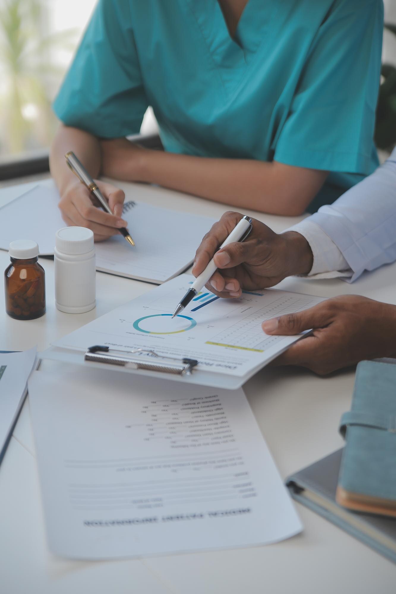 Physicians reviewing practice profitability