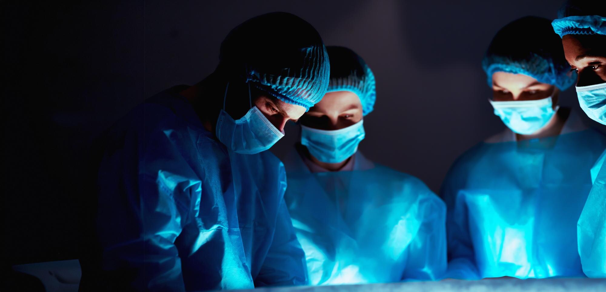 team of professional surgeons performing surgery i 344d34c49ecb3dac123e