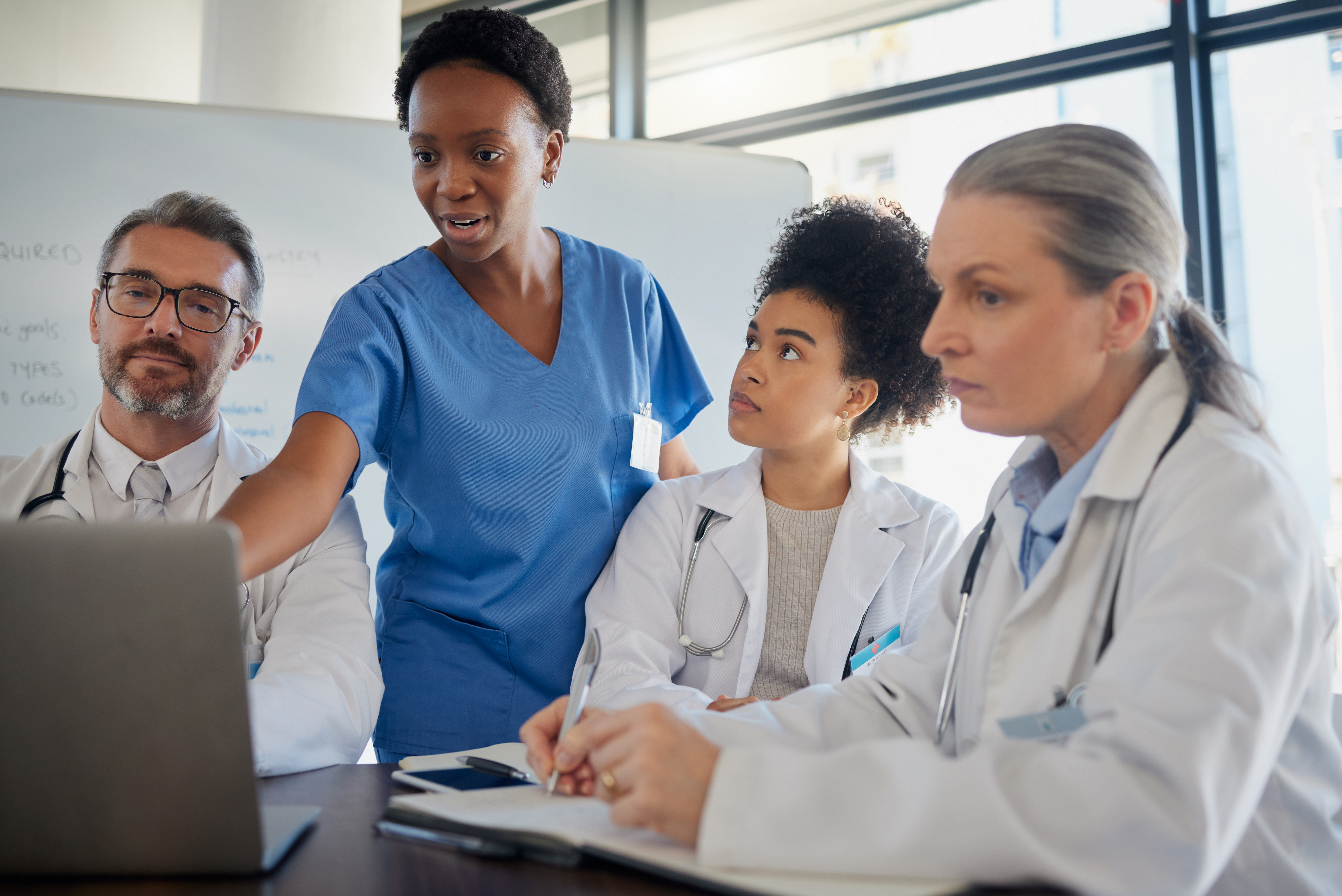 Physicians reviewing practice management reports