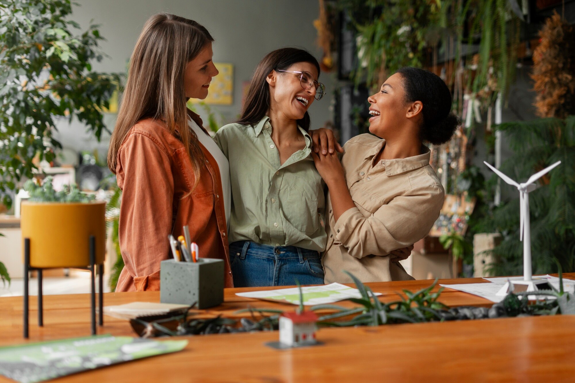 Colleagues collaborating in a green workspace, reflecting authentic sustainability values, teamwork, and purpose-driven brand culture.