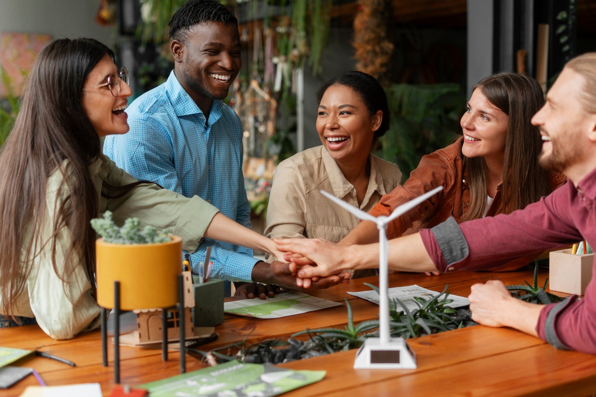 Group of professionals collaborating around a table during a sustainability strategy discussion, symbolizing purpose driven teamwork.
