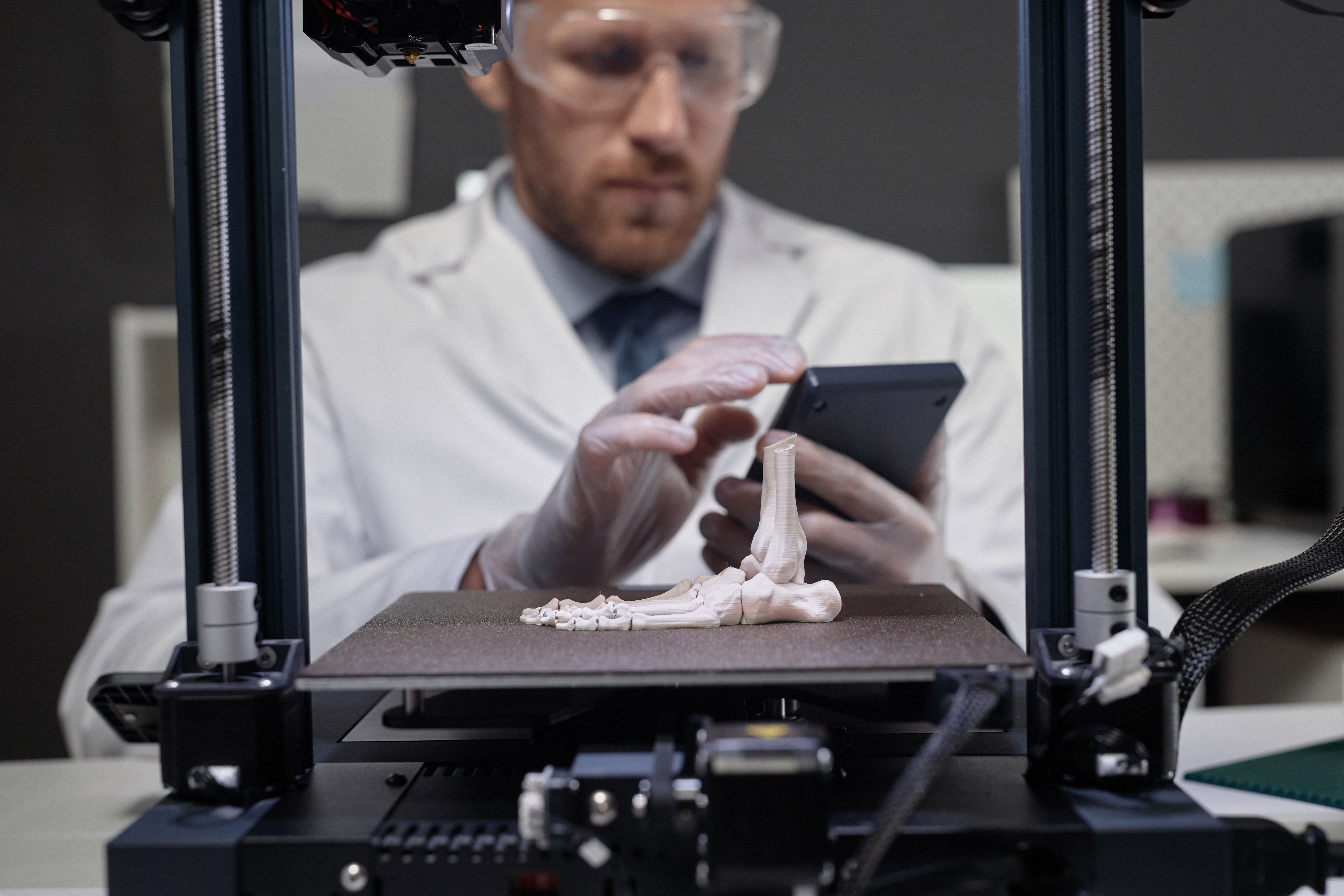 How Advanced Local Fabrication Technologies Improve Plastic Product Quality 2 technician working on 3d bone prototype 9950b3f4d71aa3567c5f