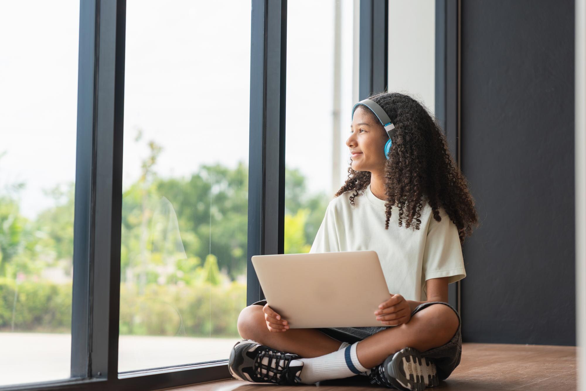 Teenage Girl With Headphones And Laptop Looking Ou Cffd359a8eacd27d04b6