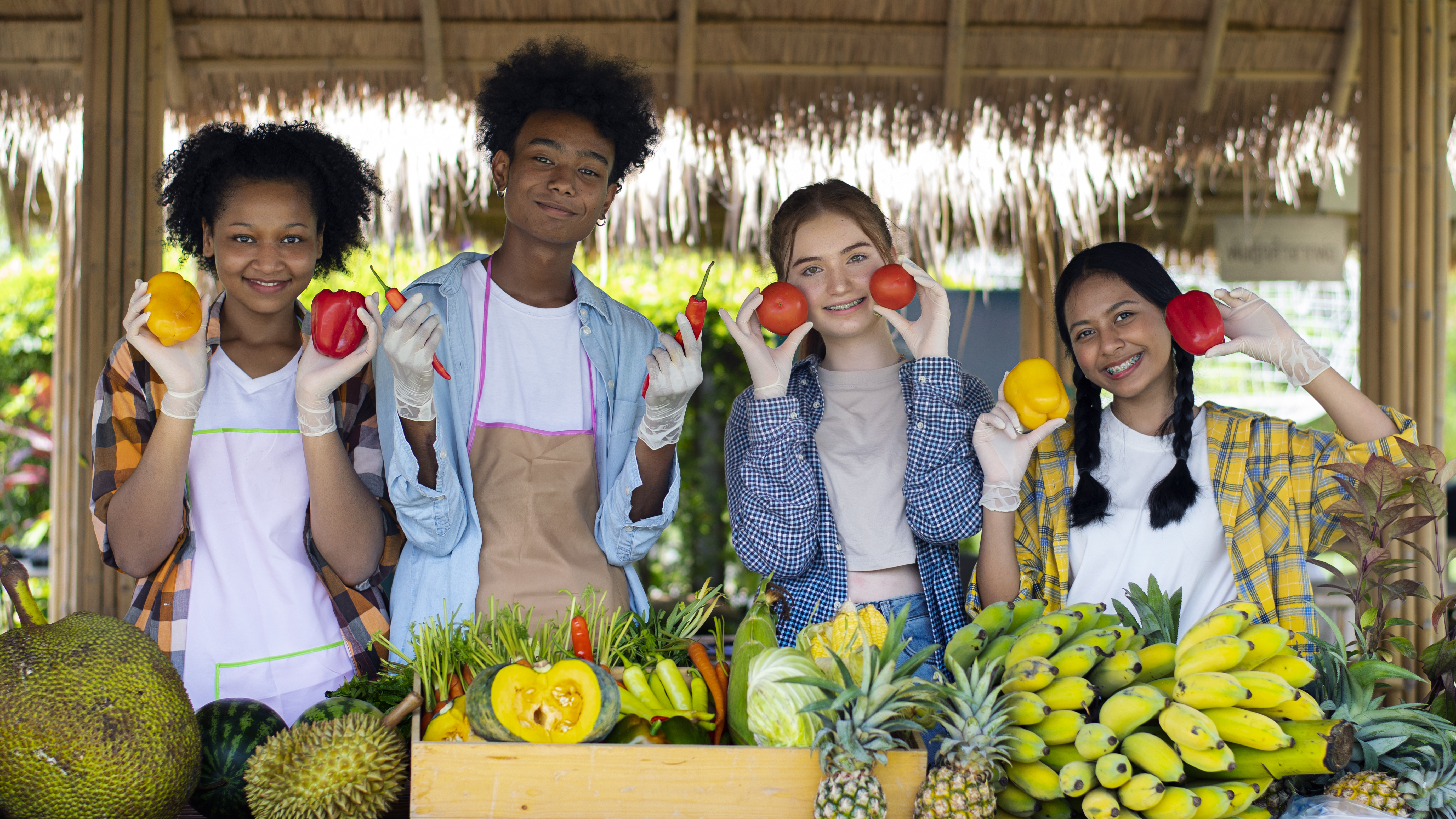 teenagers holding tropical fruits f26d24fcd60f78068f9c
