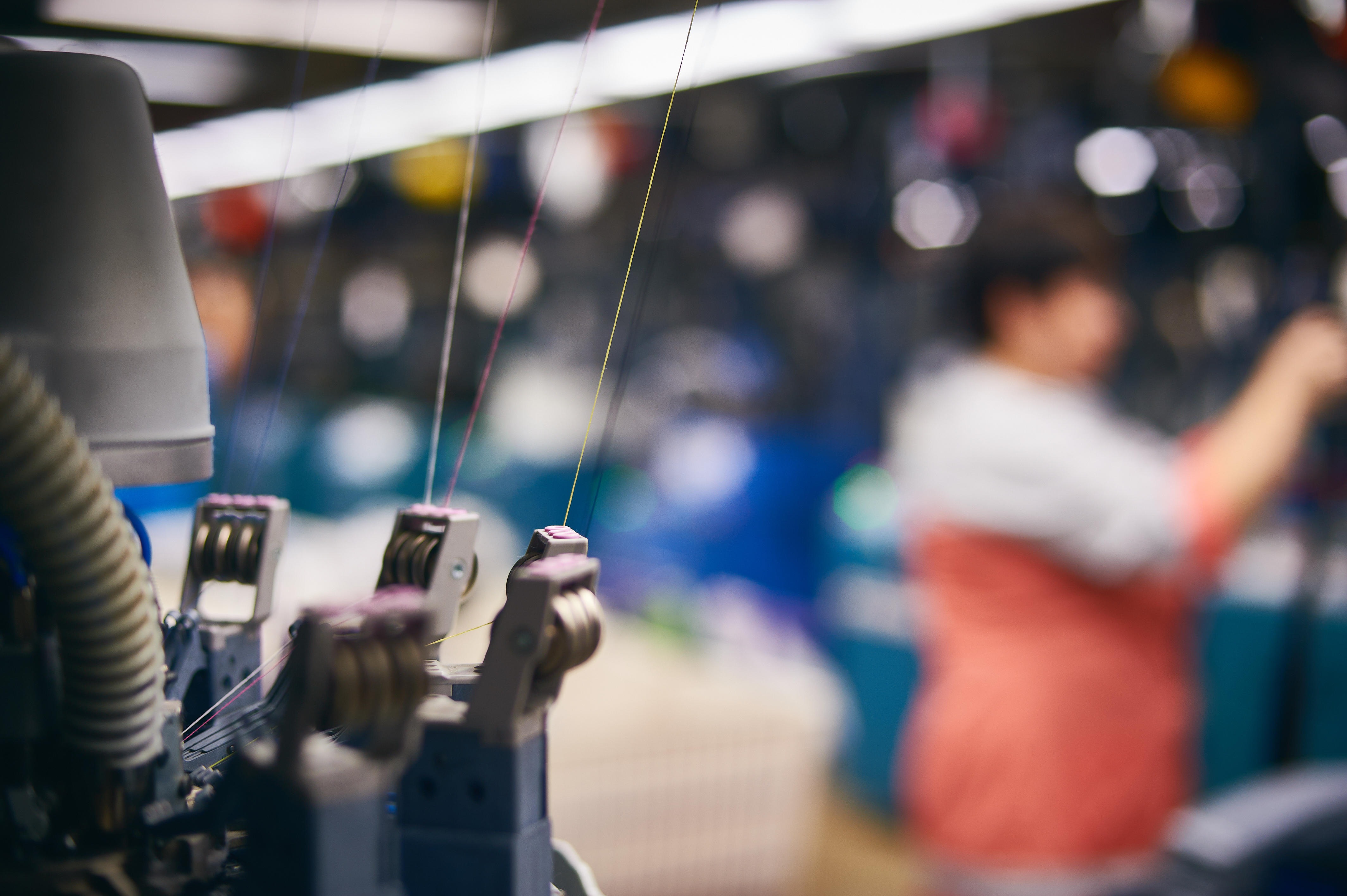 Szybka Realizacja Zamówień w Produkcji Odzieży Sportowej – Jak to Działa? 3 textile industry with knitting machines in factory b204e98724fe3a3f54dc
