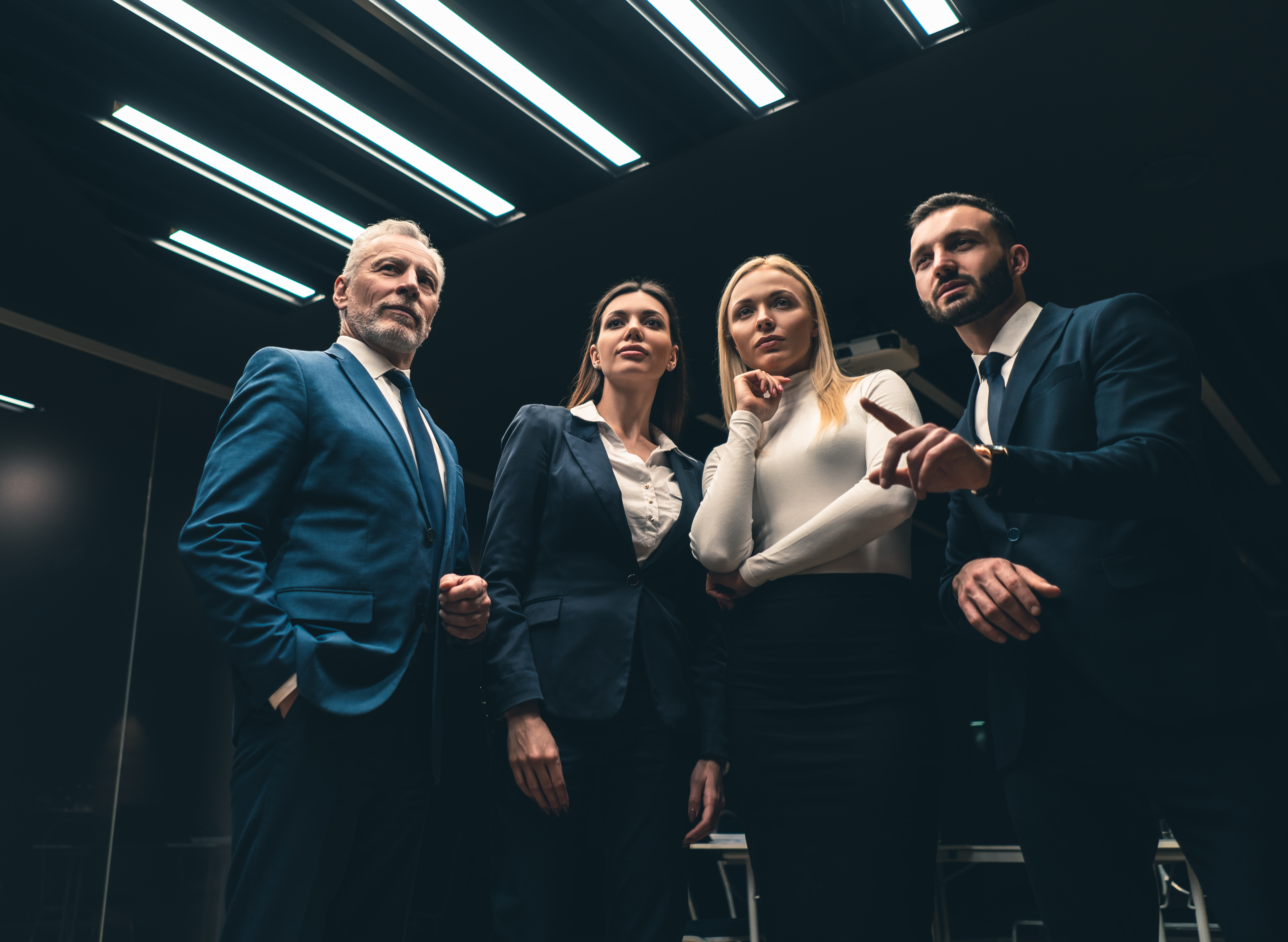 the four business people standing indoor a9136d929ca99af759a3