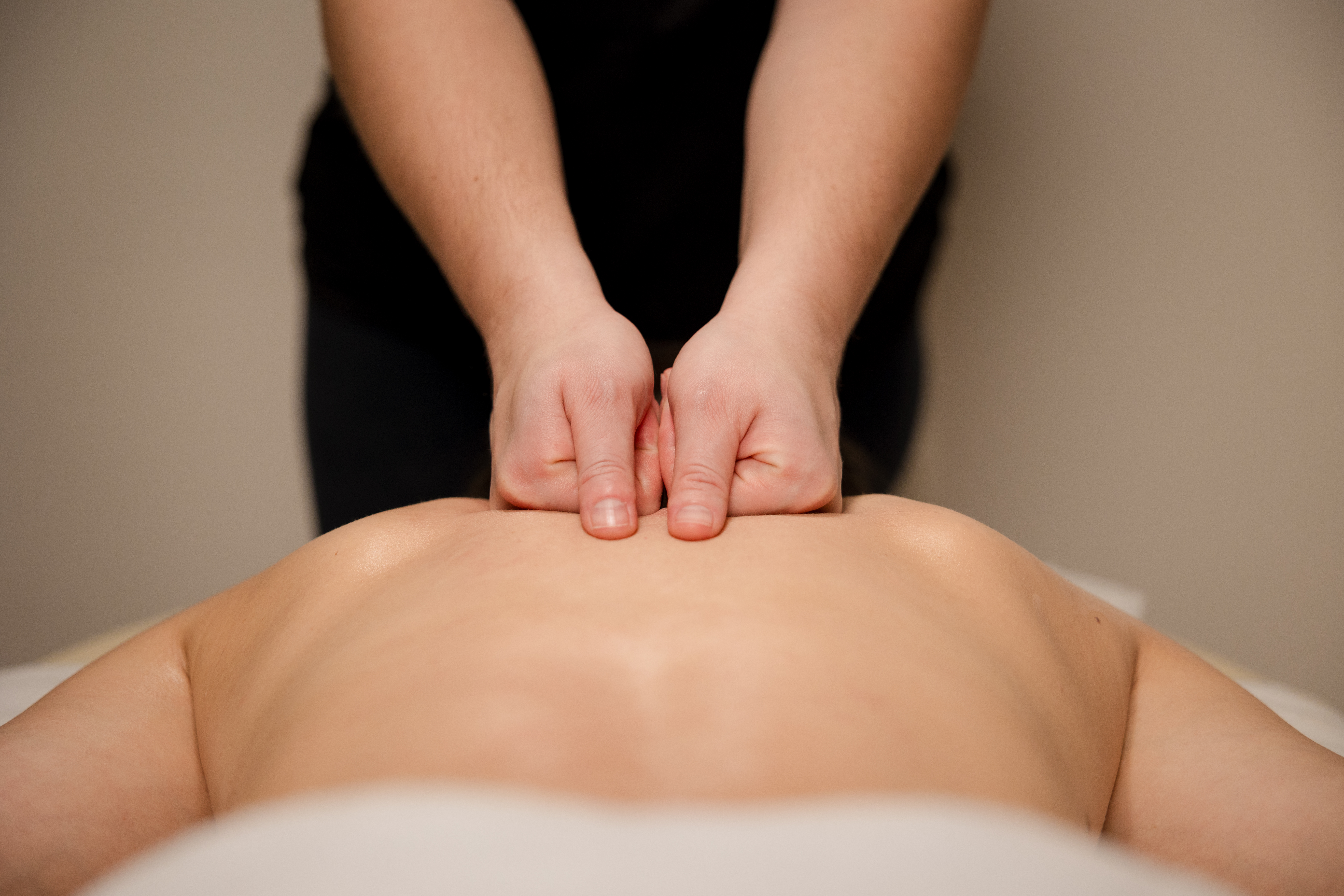 The Surprising Benefits of Swedish Massage for Pain Relief and Relaxation 2 therapist performing a lower back massage with oil e591aa48ce8a28f14073
