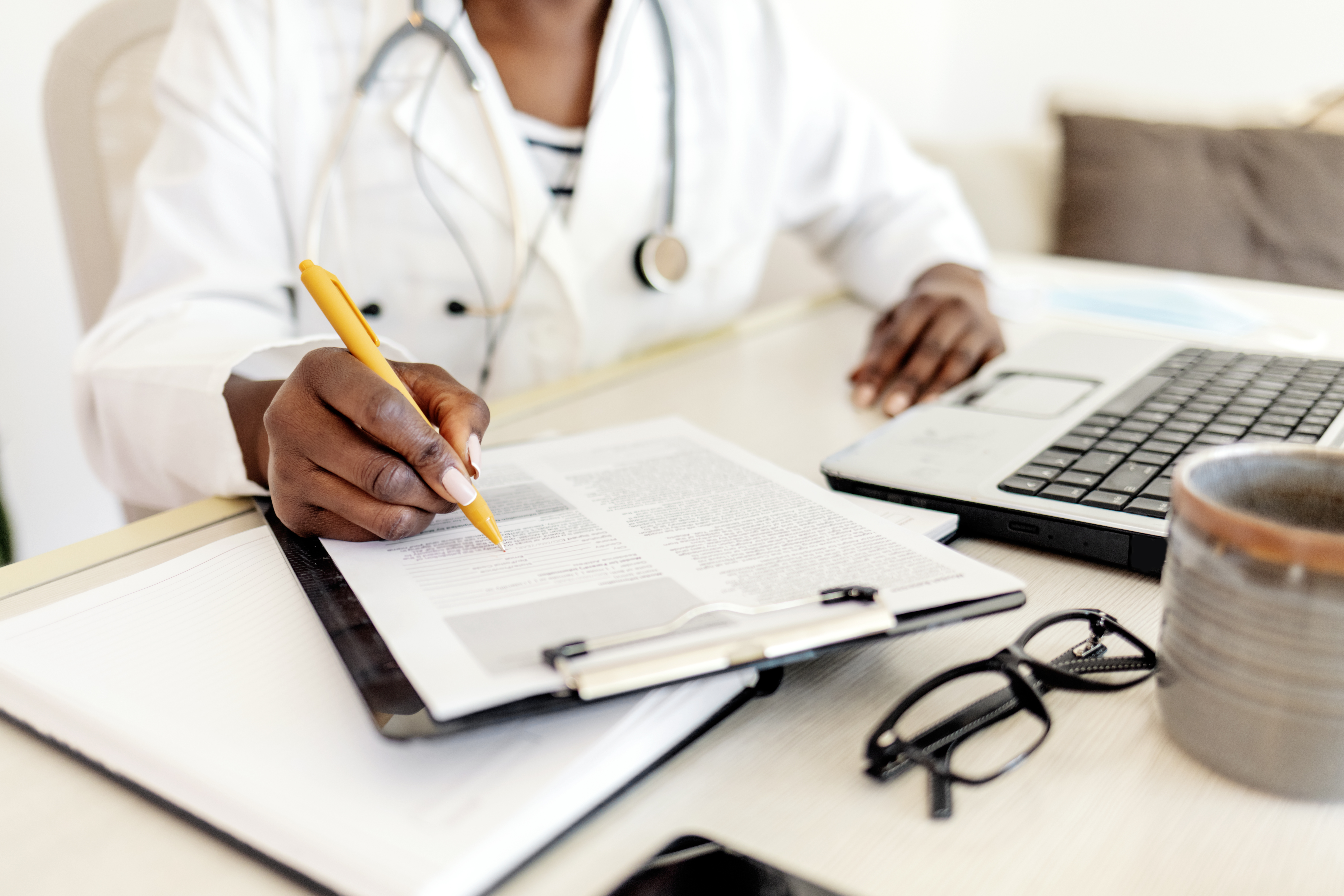 Mastering The Oet Writing Subtest: Essential Strategies Using Medical Letter Templates 3 image of a health worker writing—an illustration of the medical letter writing task in OET.