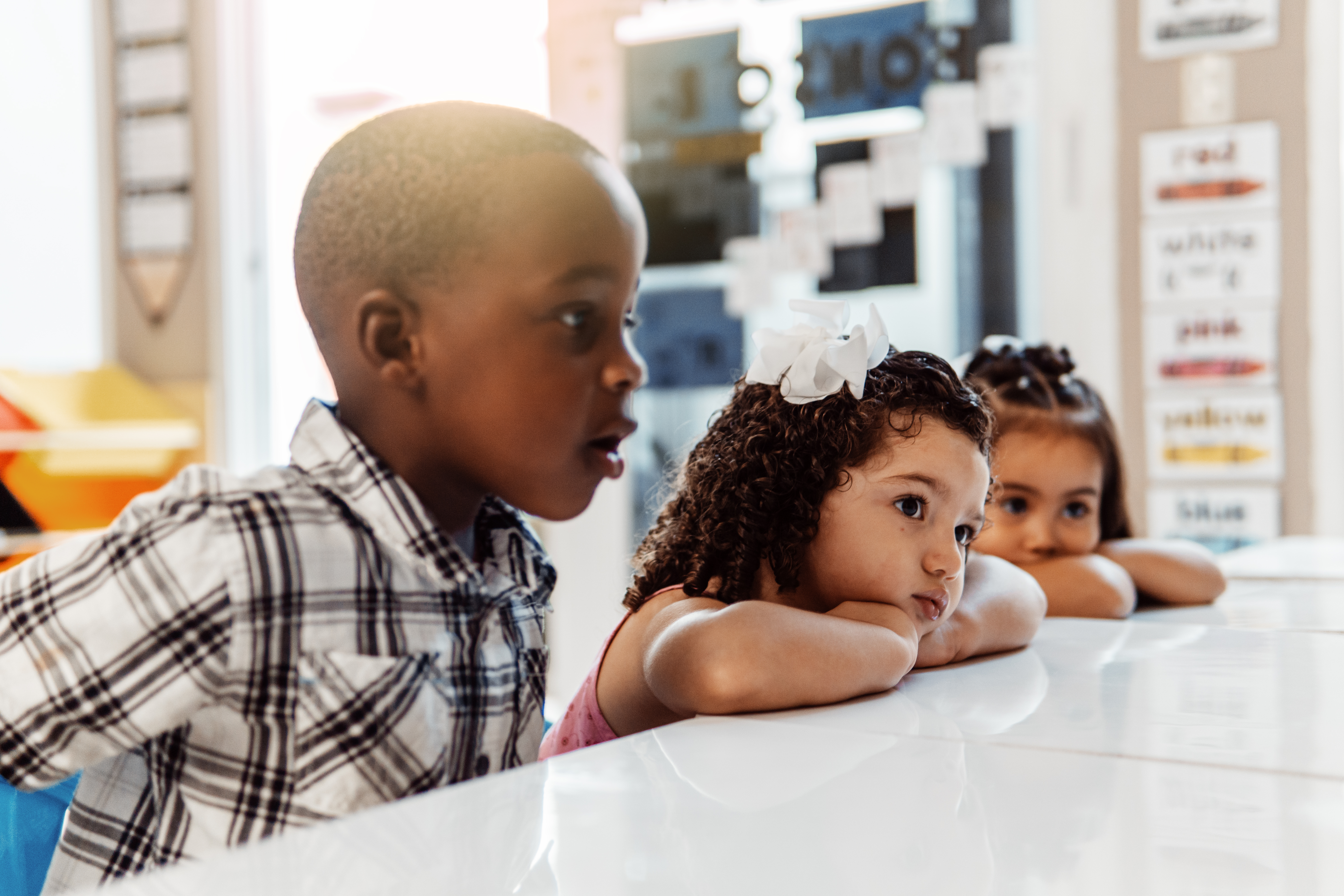 Three Little Children Paying Attention In A Class 9e68d1ef252878102309