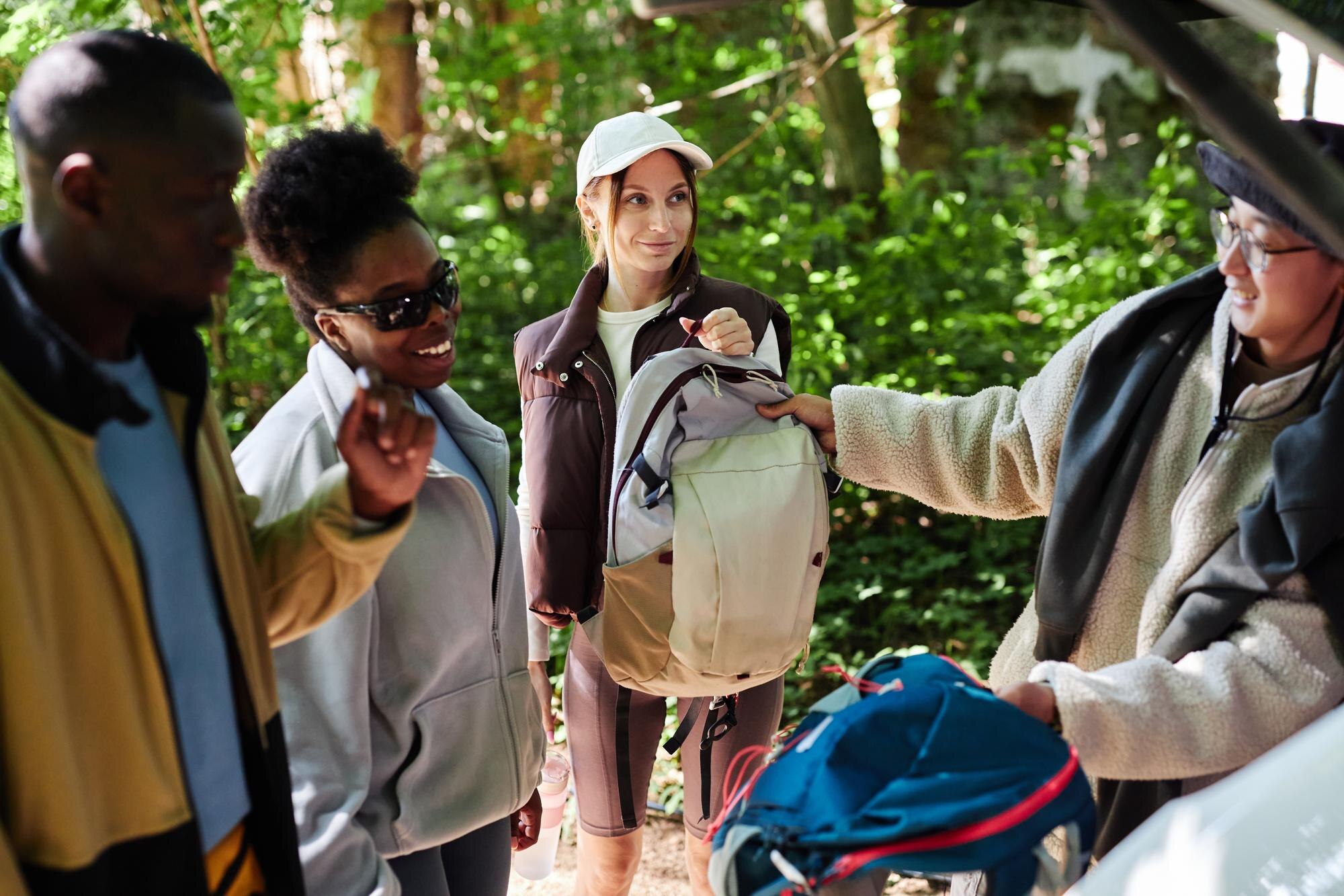 tourists unloading hiking gear from car 6216b1671f8f399dd4bb