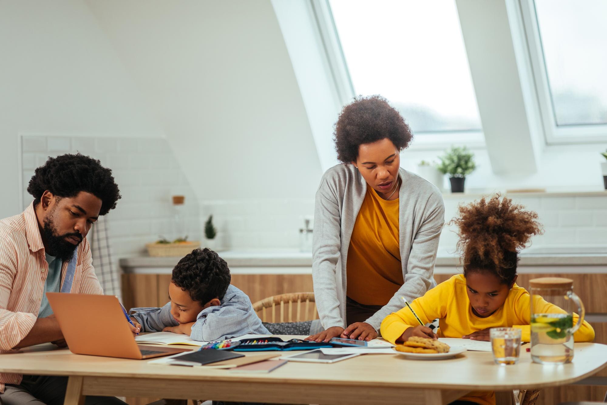 Two Afro Children And Their Parents Doing Homework 847143ac8224fd7d4771