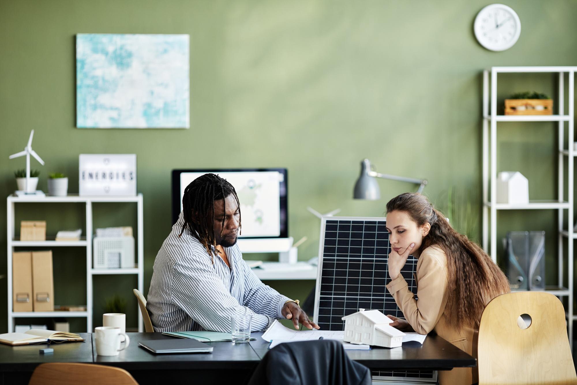 two colleagues sitting at table at office and exam 6047226fc63b17131152