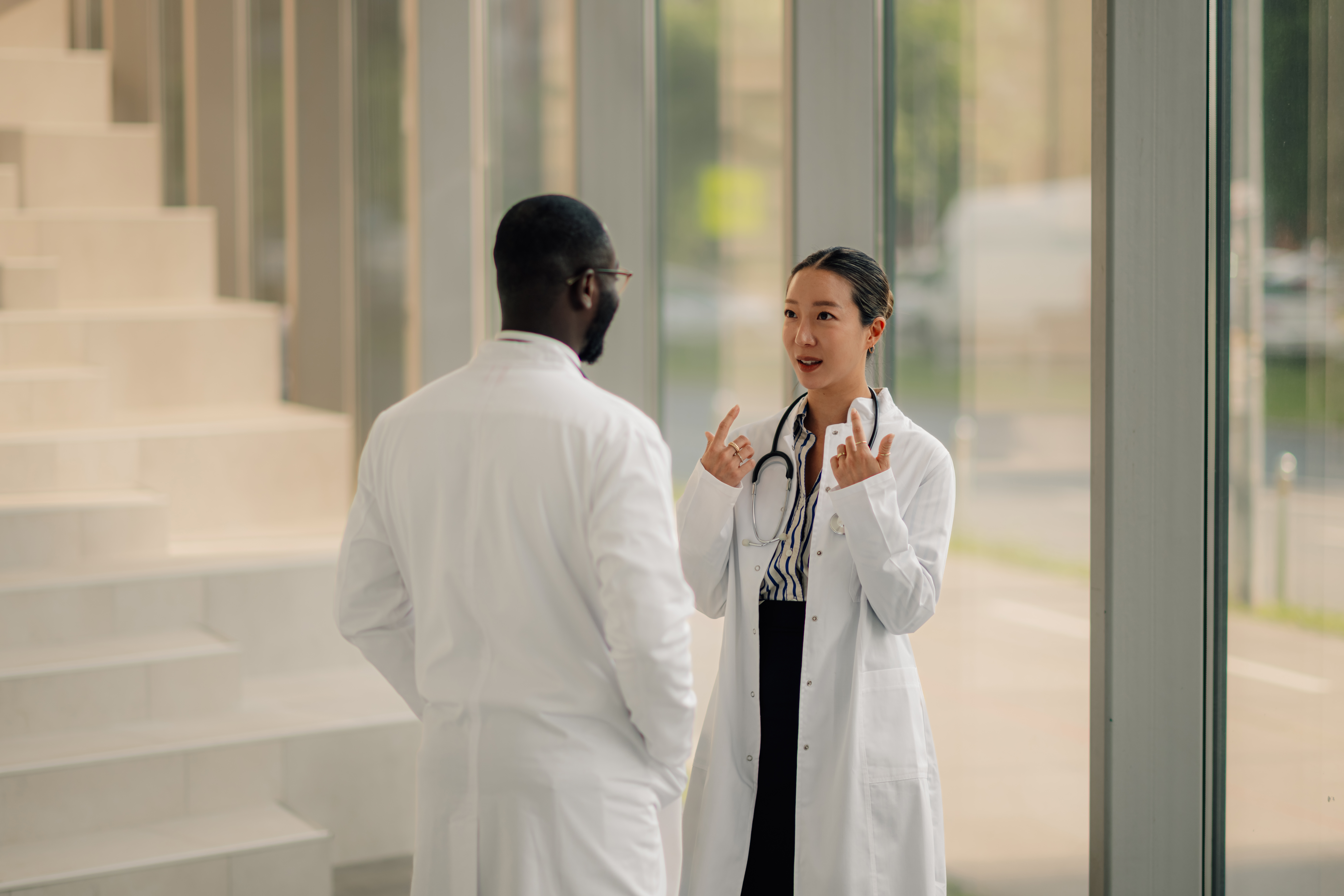 two doctors having a conversation in a hospital 36ddbbcda7d30365f3dc