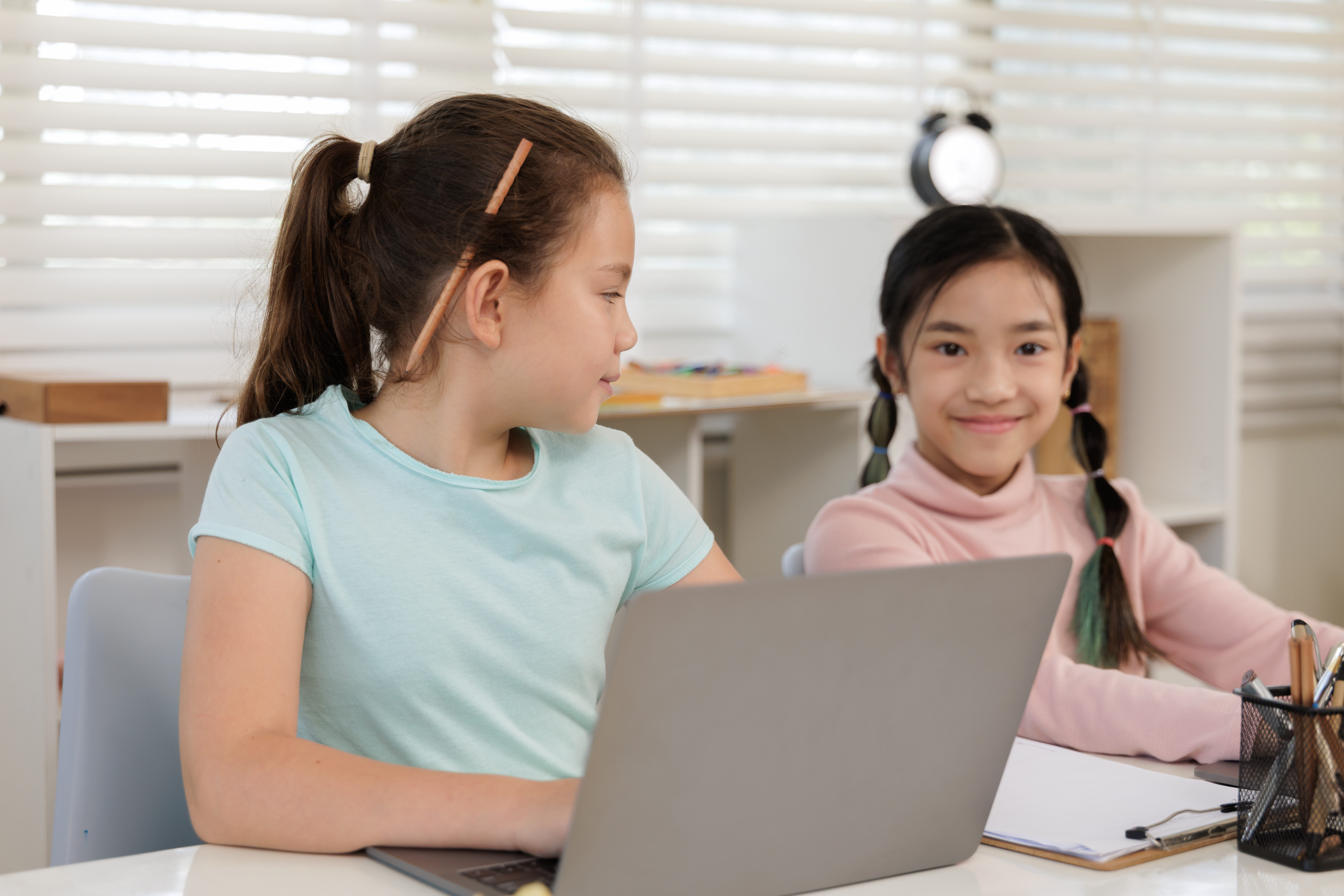 Two Girls Are Intently Focused On Their Online Cla Be751e246d97107b1efc