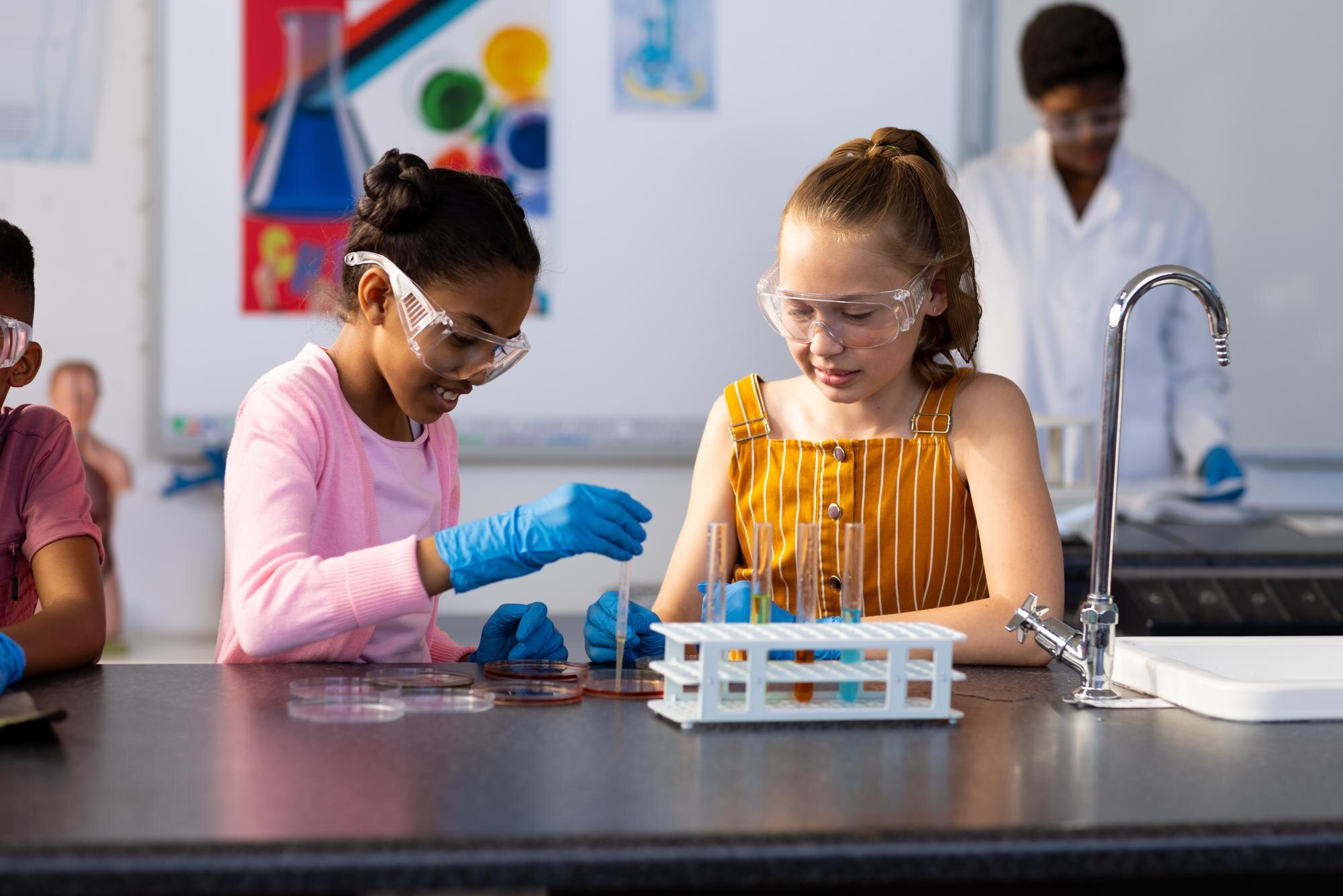 Two Happy Diverse Schoolgirls Doing An Experiment 159d254a52ed4892f15e
