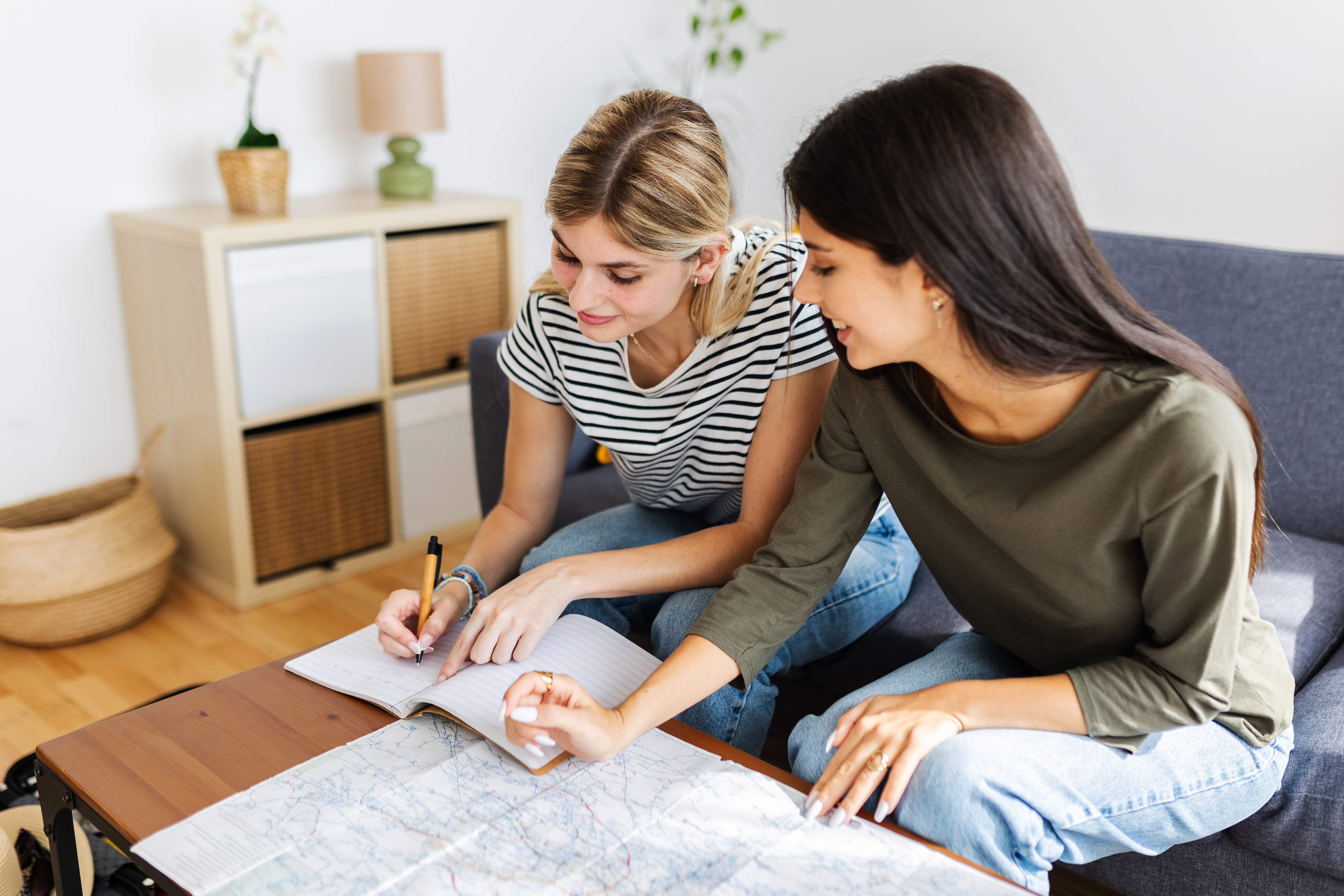 two happy young girls planning their next vacation e3dff718fa4b86b33395