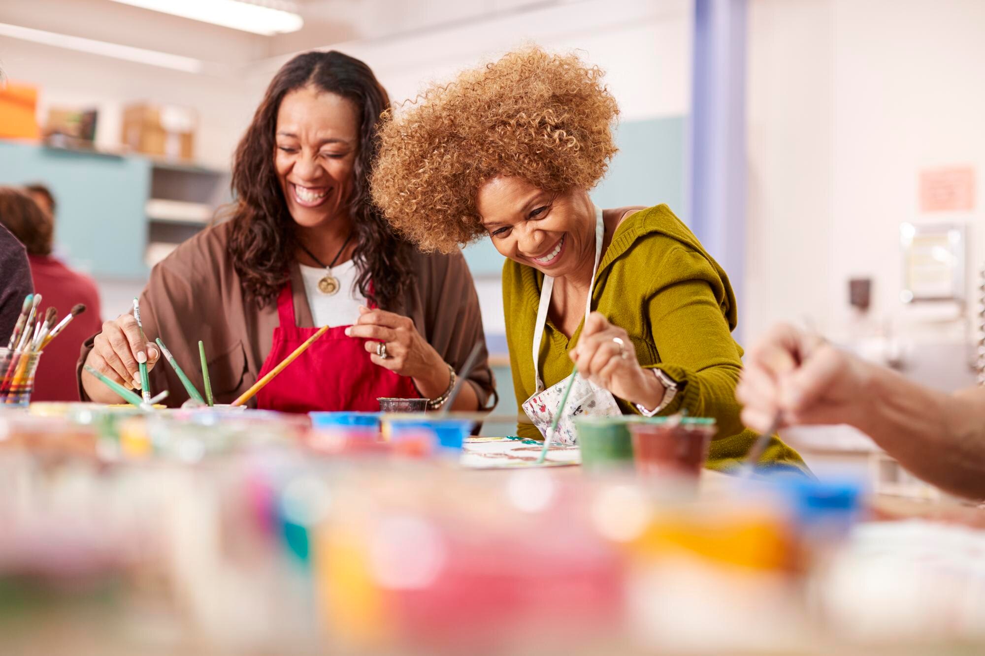 two mature women attending art class in community e898f4f495bcf0e319cf