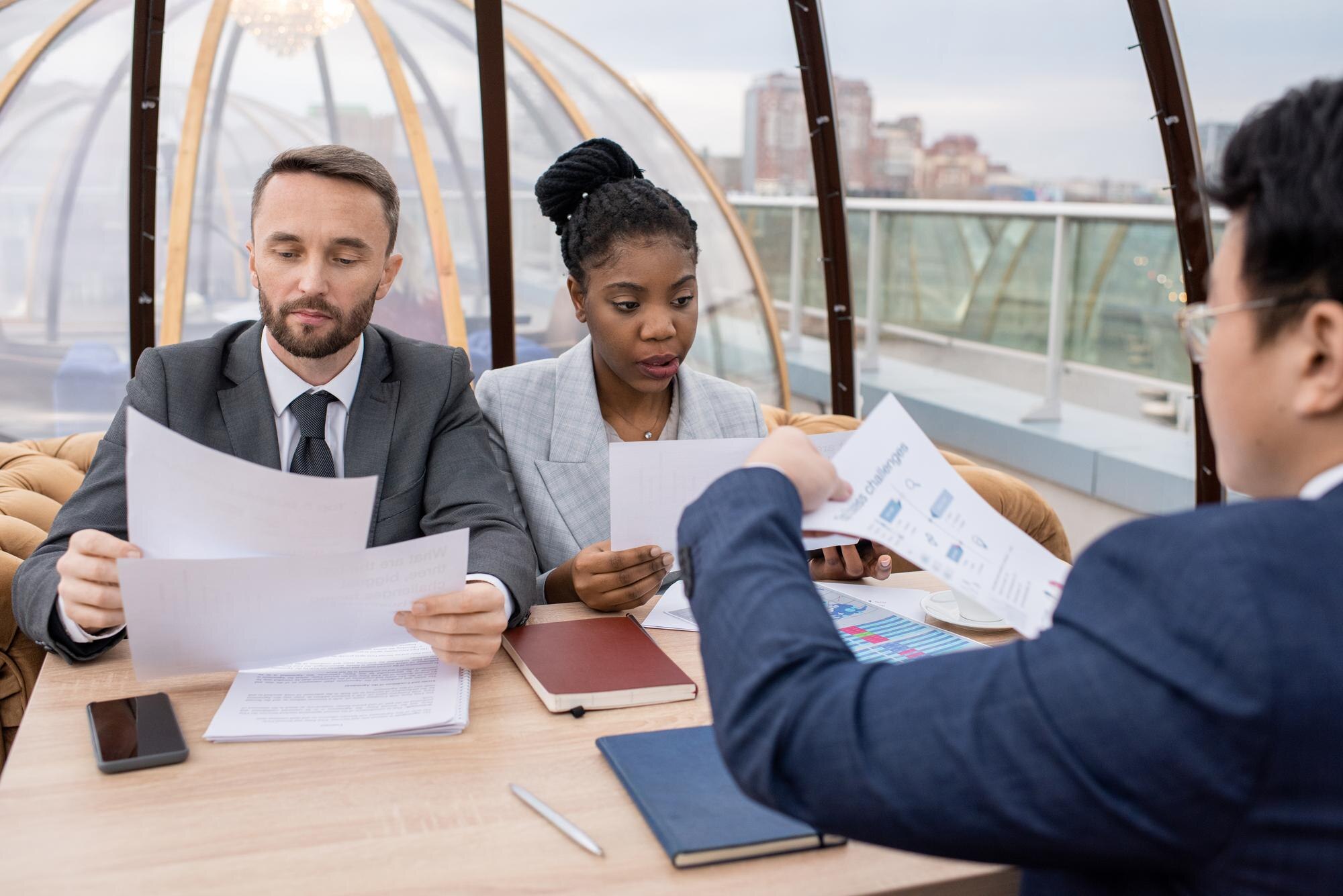 Checking Your Australian Visa Expiry Date: A Step-By-Step Guide 2 Two Serious Colleagues Looking Through Papers At M Fac8Bb68321938A8B468