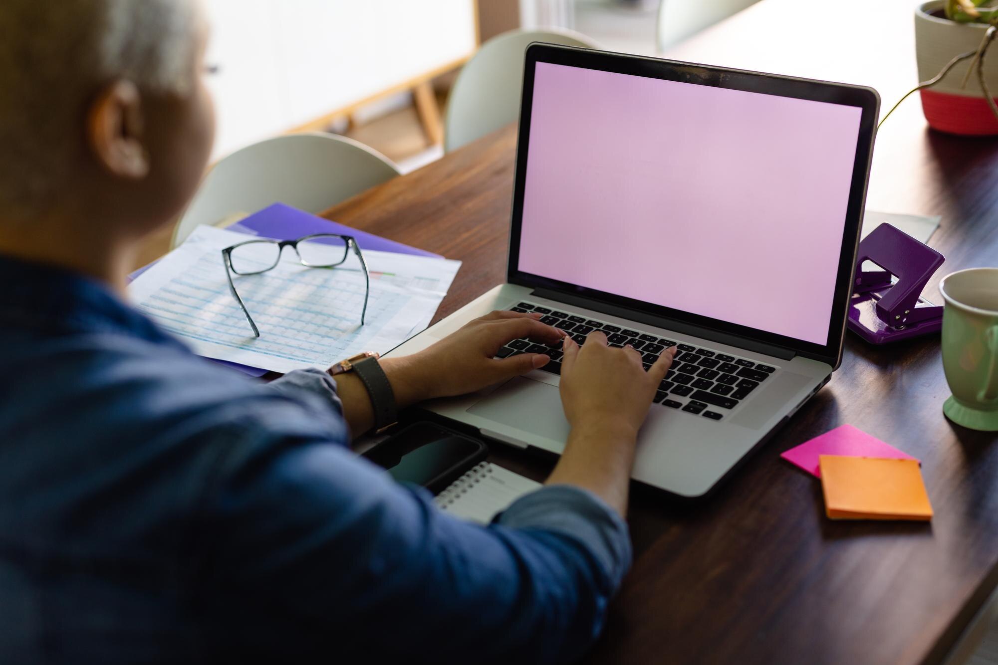 unaltered biracial woman working on laptop with co 12f9fc64de082ad1a784
