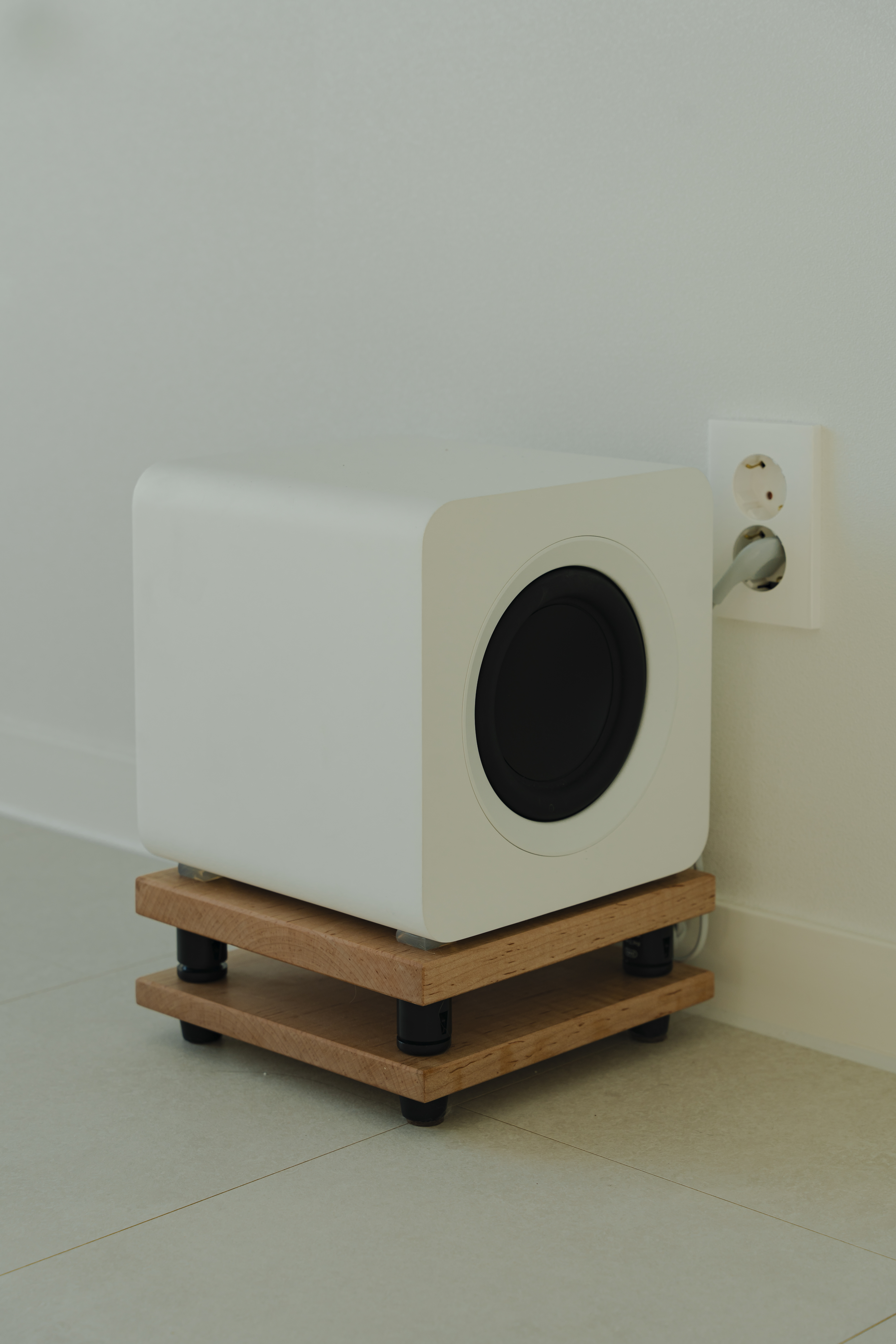 white subwoofer on wooden stand 31e1e28b9660bf17e3f0