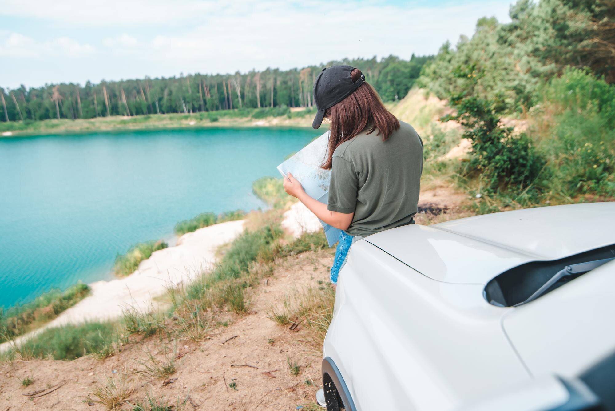 How to Plan the Perfect Multi-Day Self-Drive Tour: Expert Tips for Freedom, Comfort and Discovery 4 woman checking with map on the suv car hood lake w d3e1af20b08ebe5c7b1b BTOURS