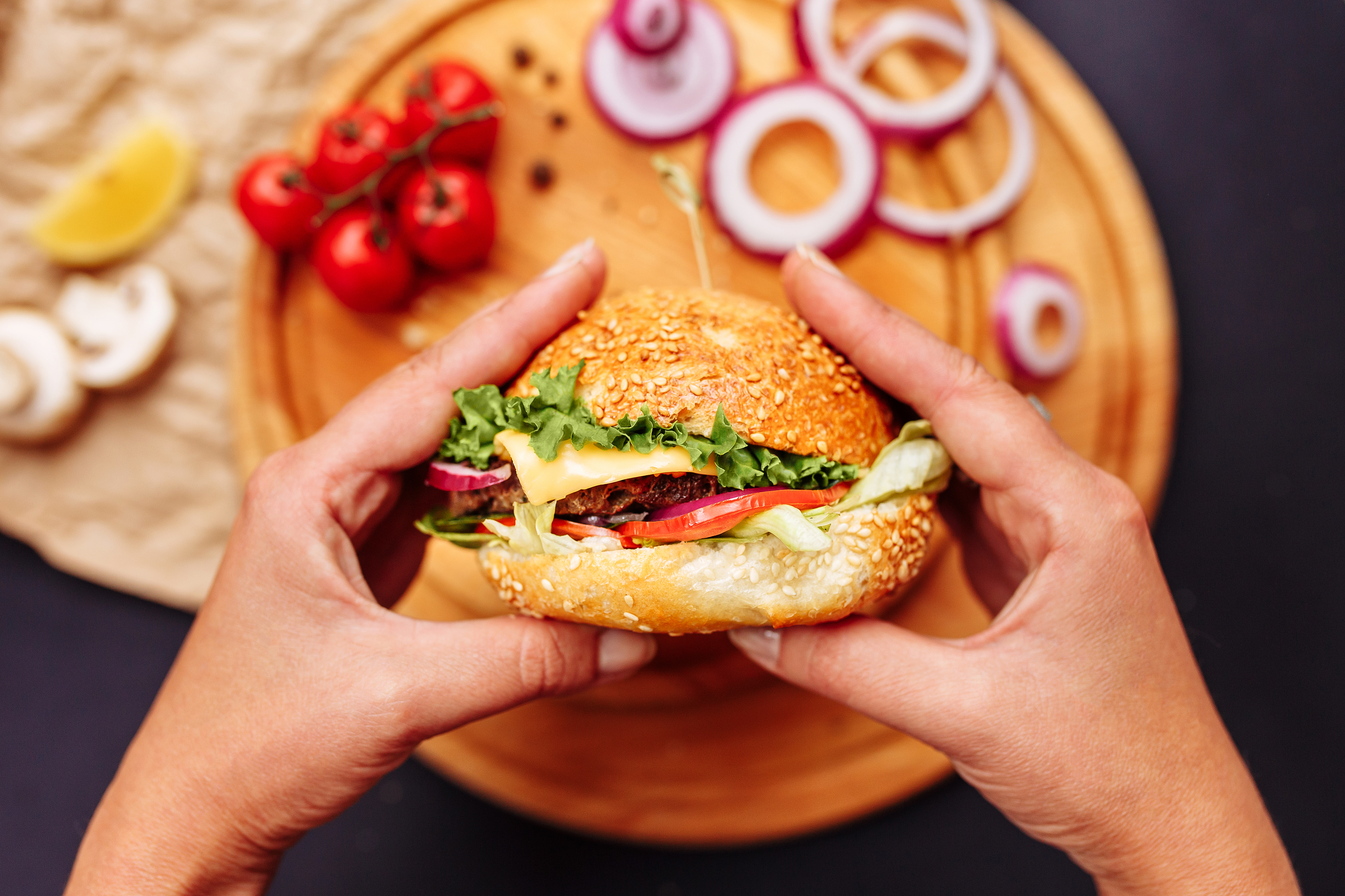 Balancing Taste and Nutrition: Discover the Jubilee Juice & Grill Way! 1 woman hands holding fresh delicious burgers with f 4c9fafdf946fa821e97f