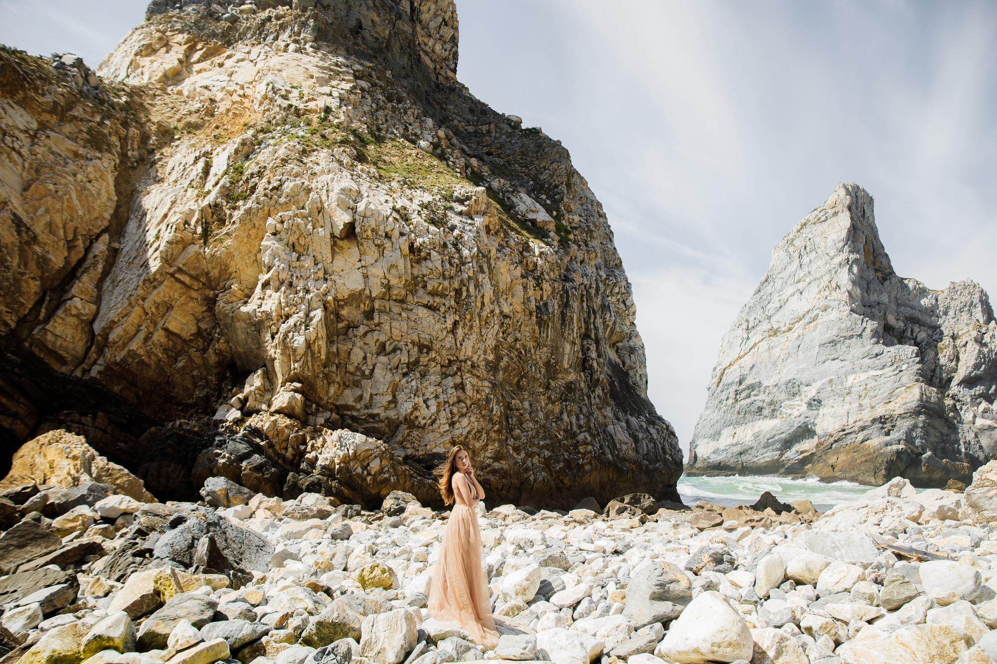 woman in long dress near rocks and ocean f2f6b867dbbbb969468f BTOURS