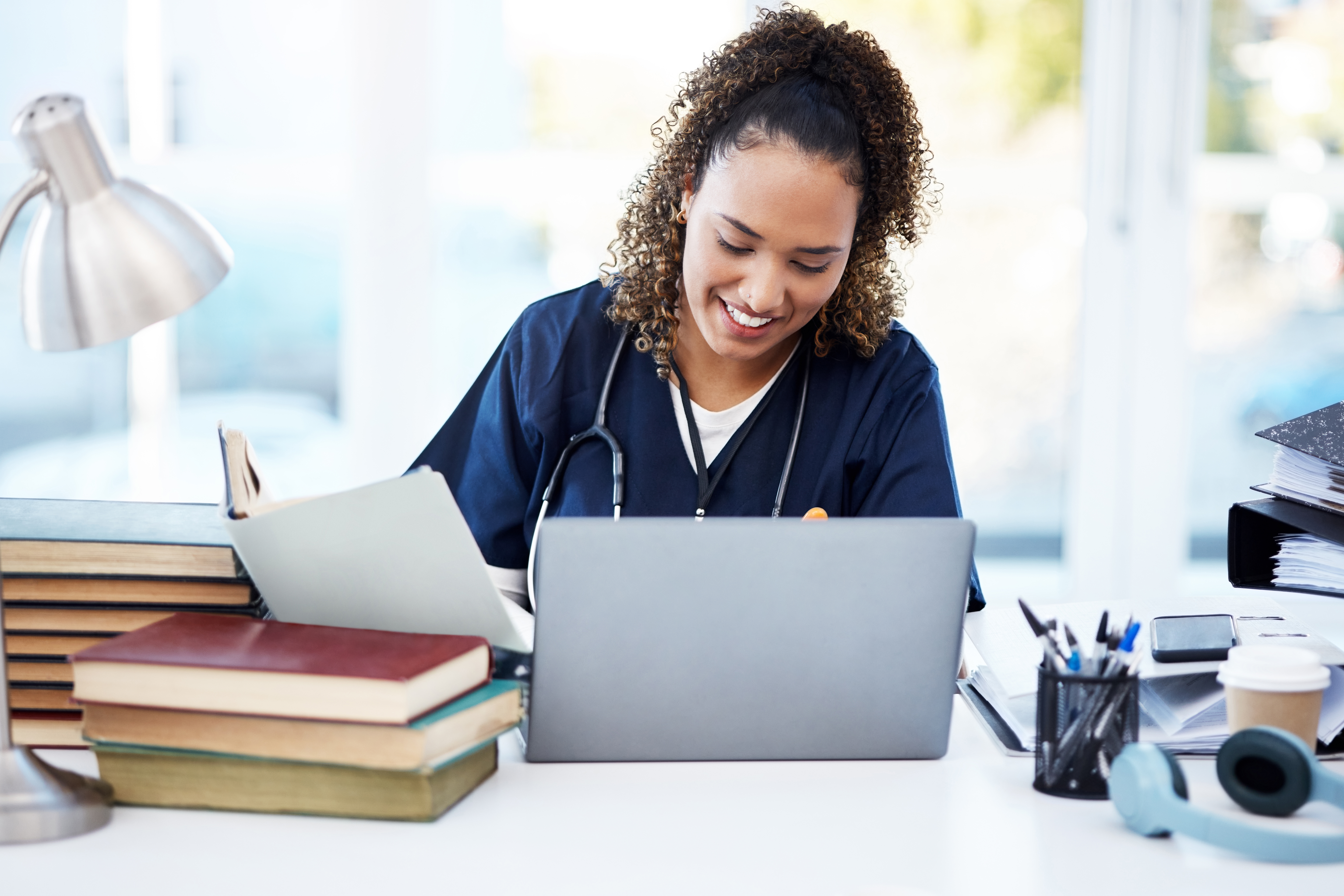 Master The Oet: Balancing Your Studies With A Busy Healthcare Career 1 image of a healthcare worker in her office- #the best oet preparation course.