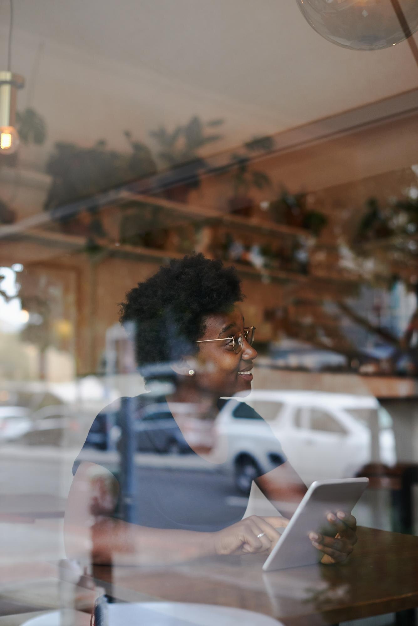 woman looking at camera while using mobile phone 5d1ce2b14b48a7a1e61d