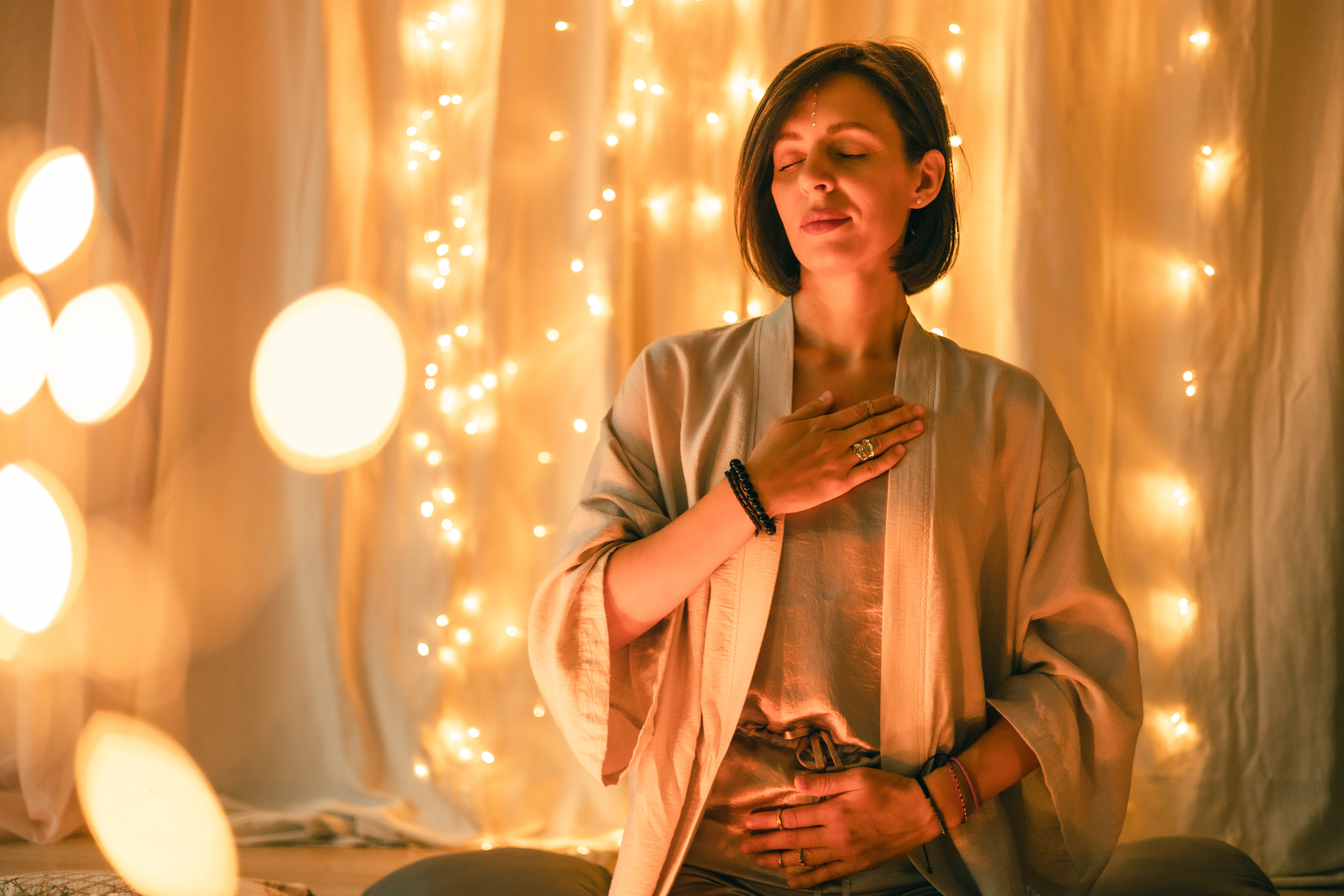 woman meditating with hands on heart and abdomen s 96a2696cabc2517b3ad9