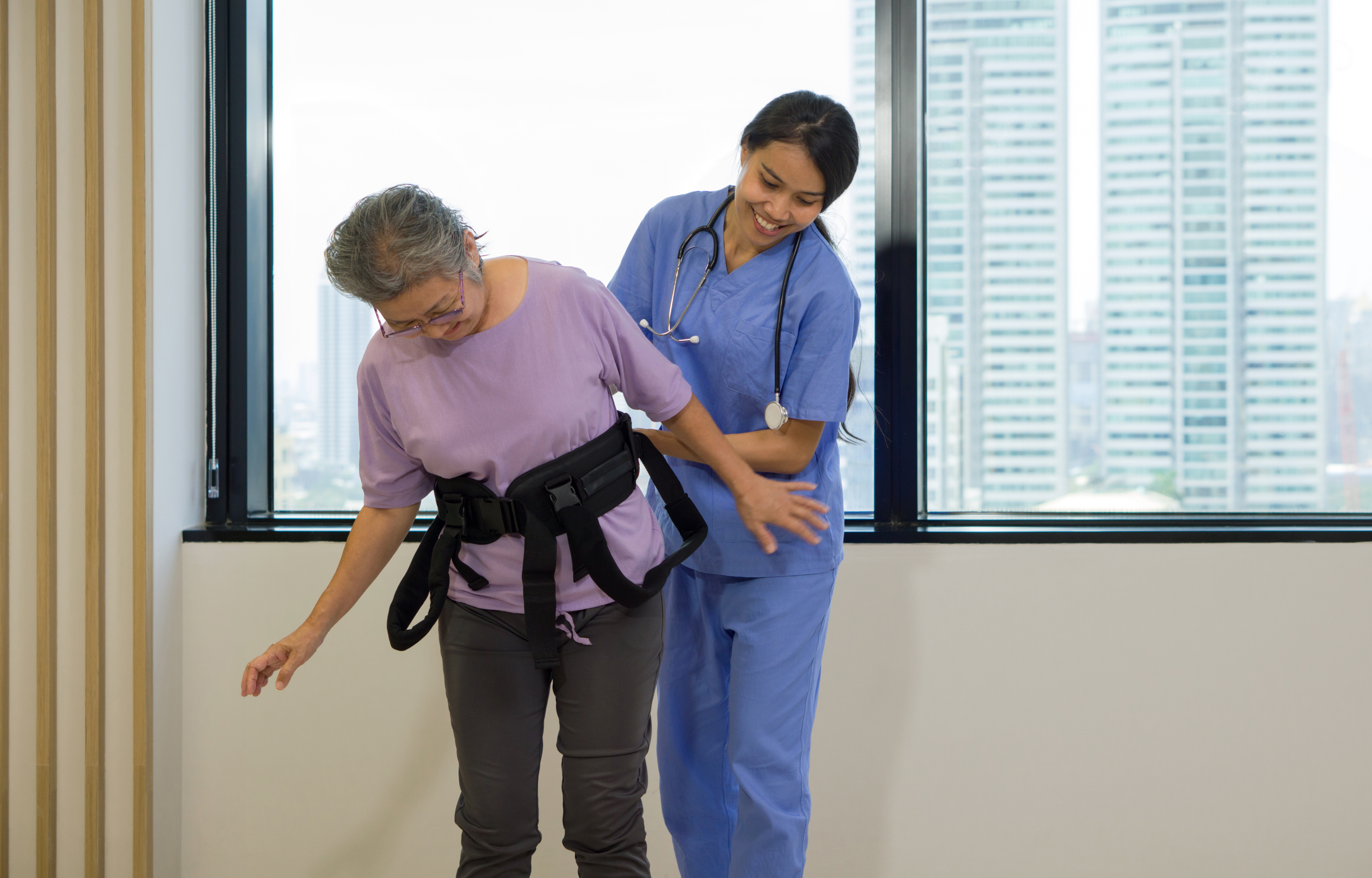 woman physical therapist in blue uniform help an e 5af82617bd62a8273eff