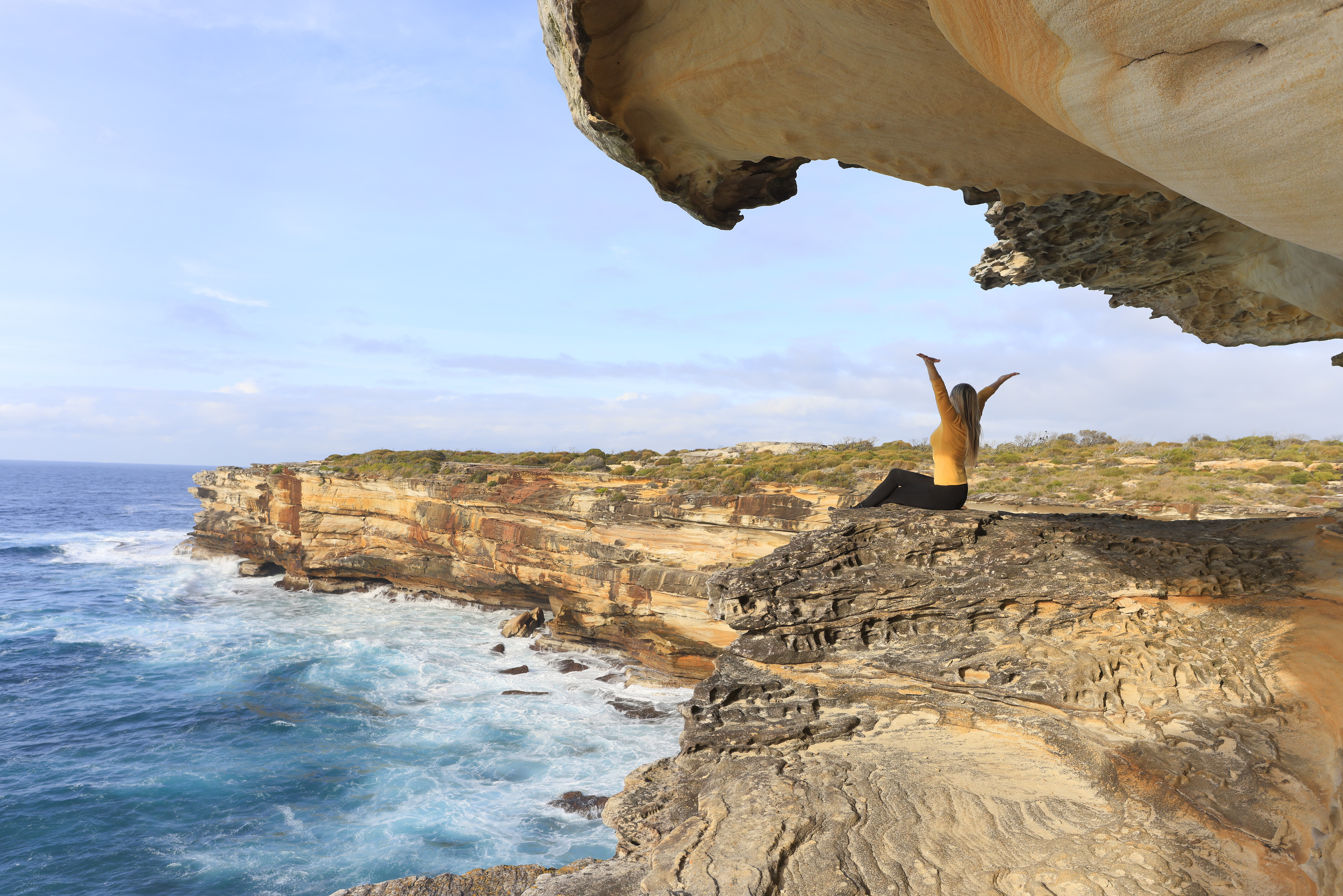 woman sitting in sandstone cave enjoying freedom 12f5f0aadc509722f59e BTOURS