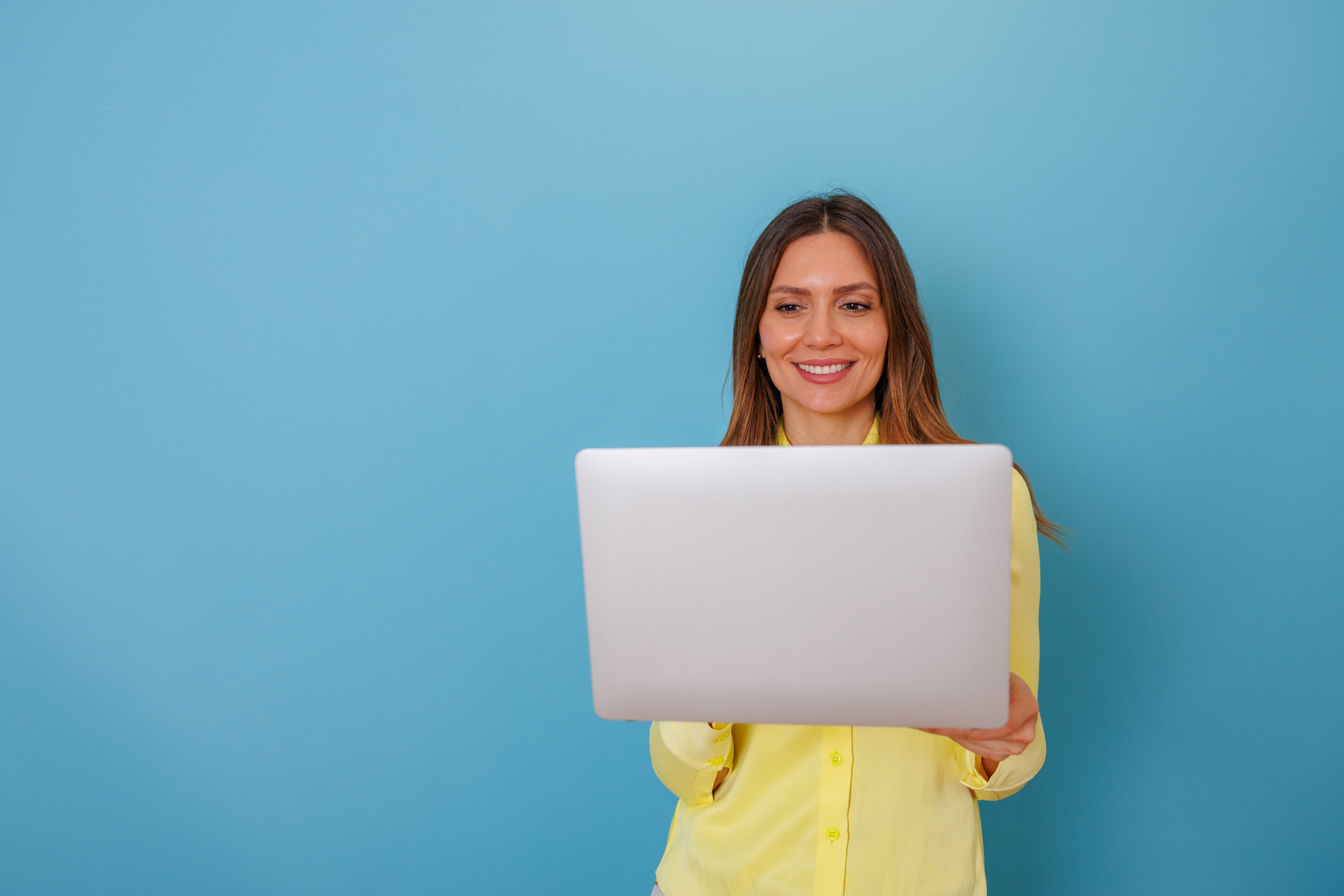 woman smiling and using laptop computer for remote 76600bf5823c14bcd58a