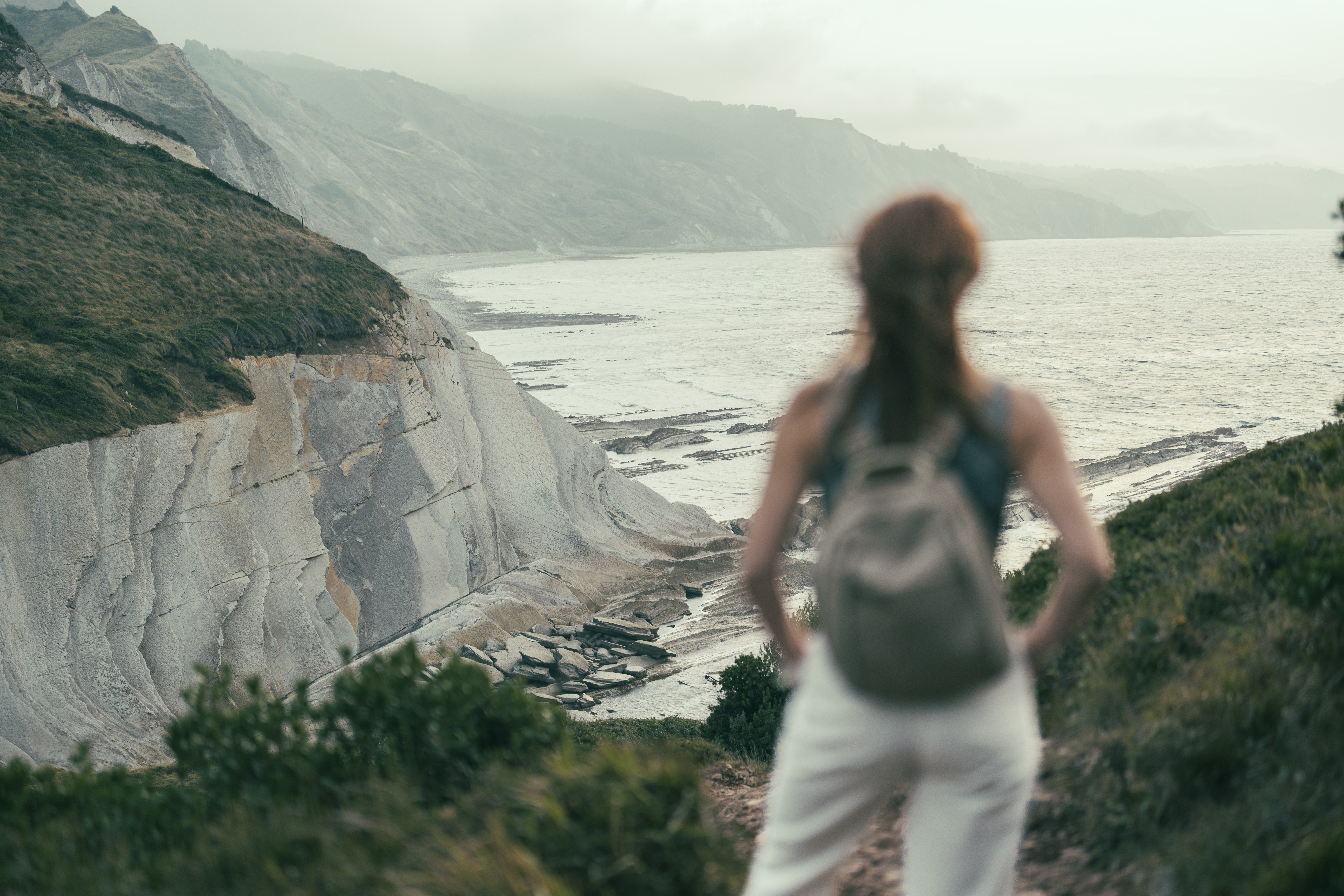 woman standing out of focus looking at the flysch ee07efada7ffc1f9a5fd BTOURS