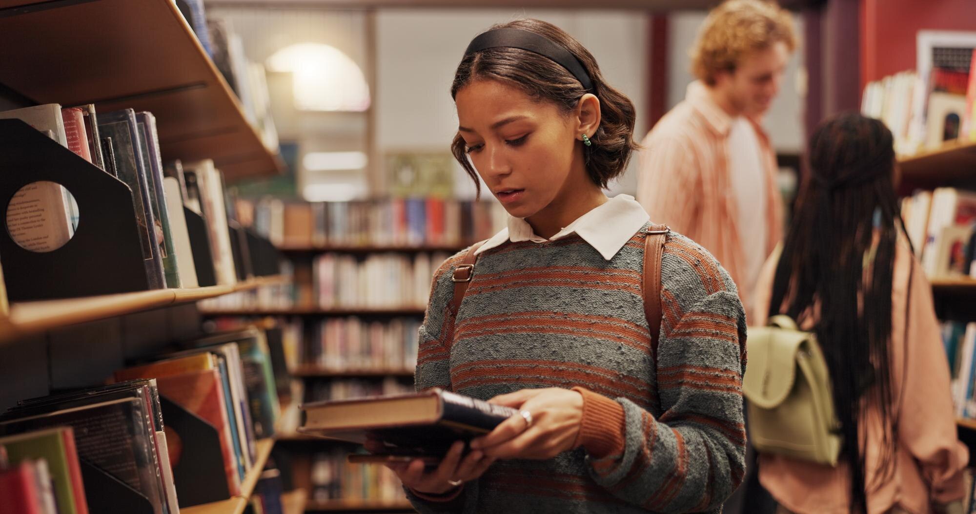 woman student and reading book in library for lear 9e68e9f20b25b82511ab