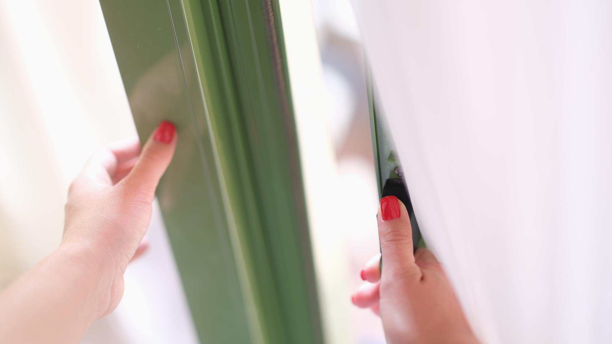 How to Use Polycarbonate and Acrylic for Winterproofing: Clear, Tough, Cut-to-Size Solutions 2 woman tries to open door by holding window or door d4501d87858a7b3f3819