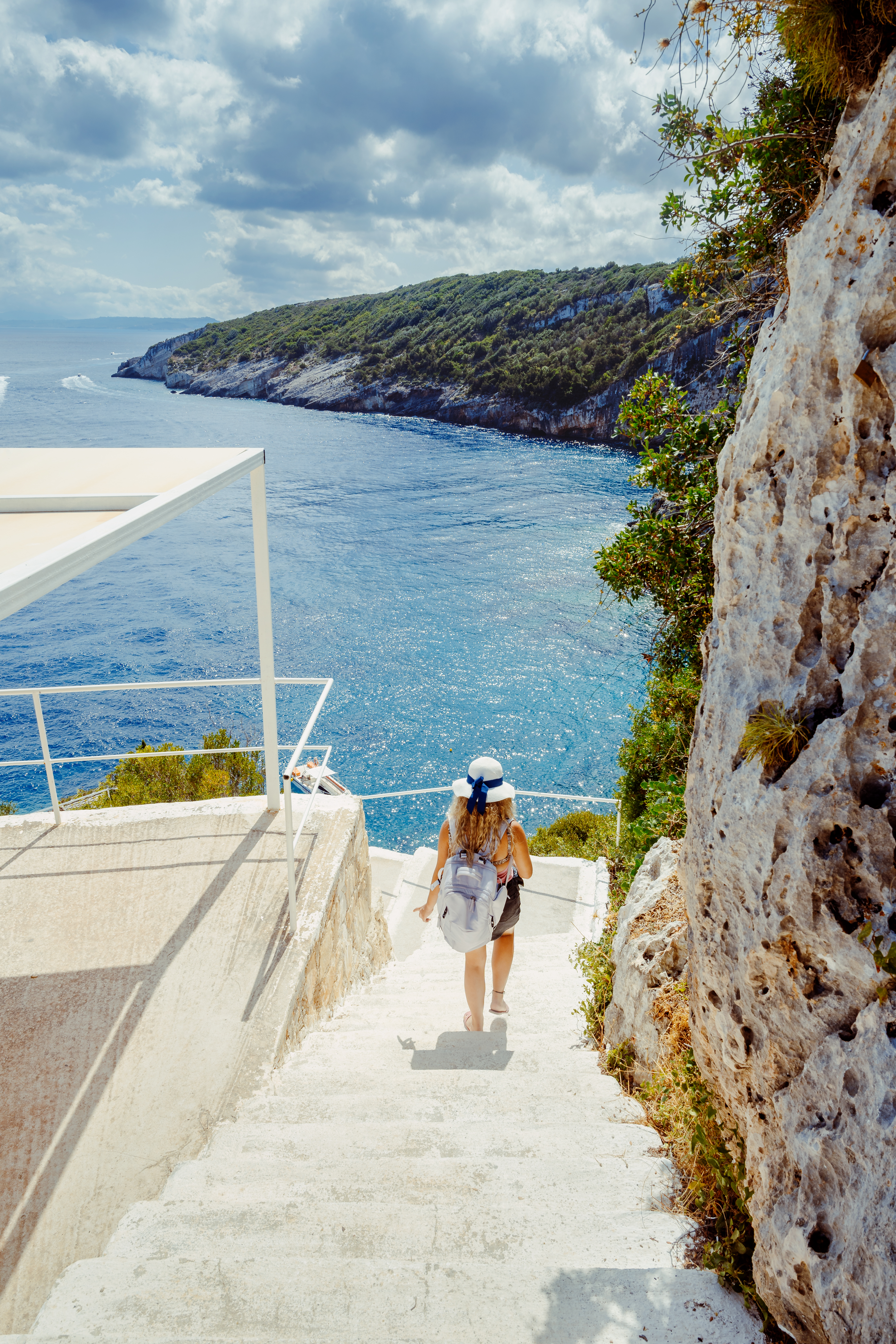 woman walking down stairway on greek coast 3775554eb8f1bbcd8d86 BTOURS