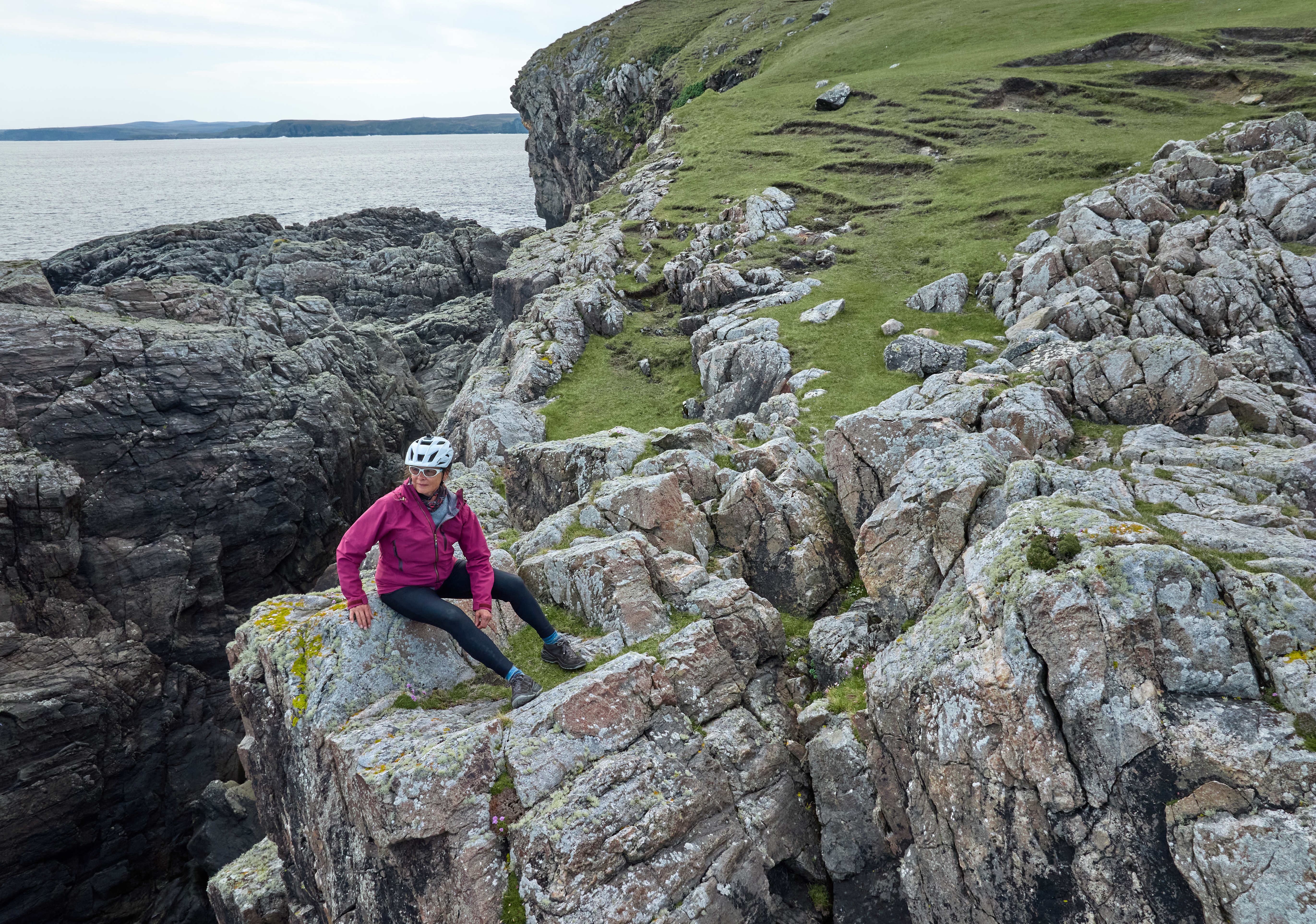 woman watching the ocean surf on a rocky cliff in ca33bb5e95621b4e4af5 BTOURS