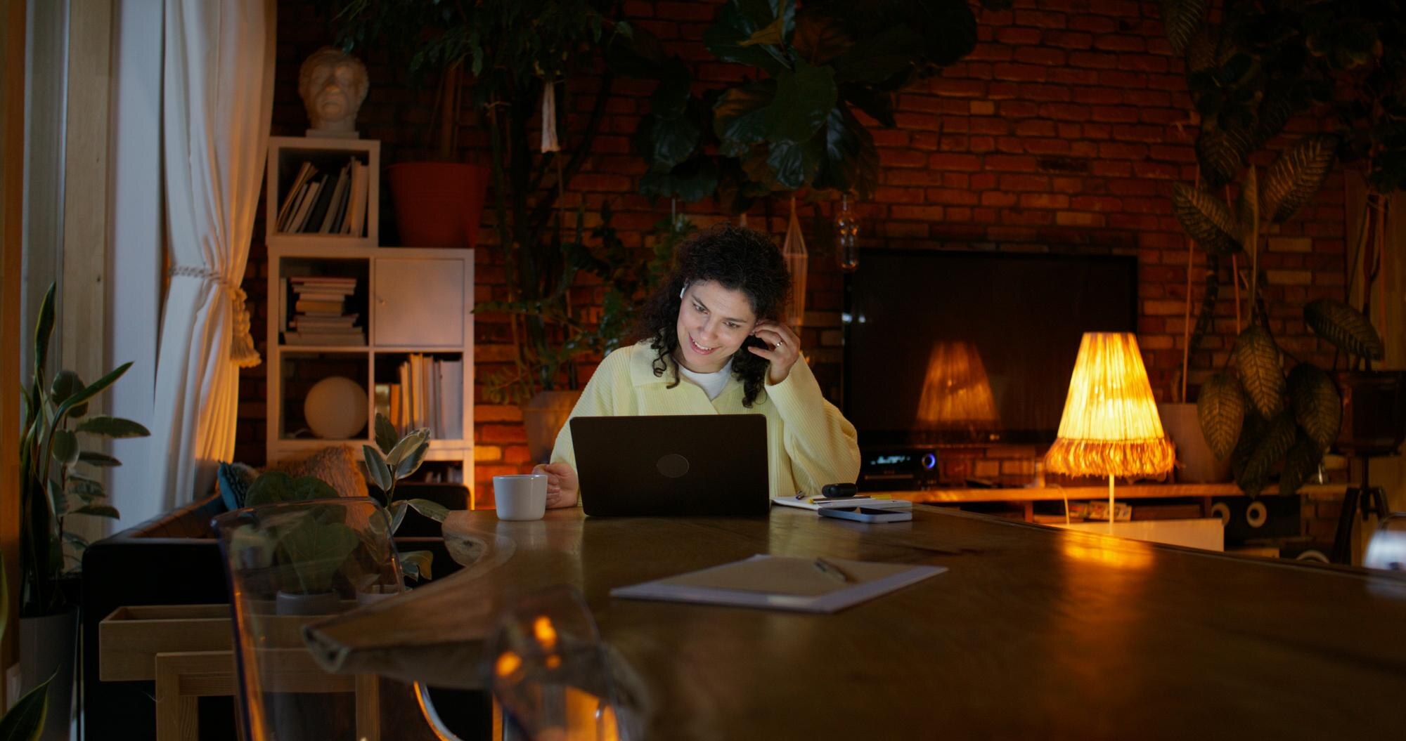 woman working on laptop at home with plants and co 50e31ba1f9fd18cdf5a8