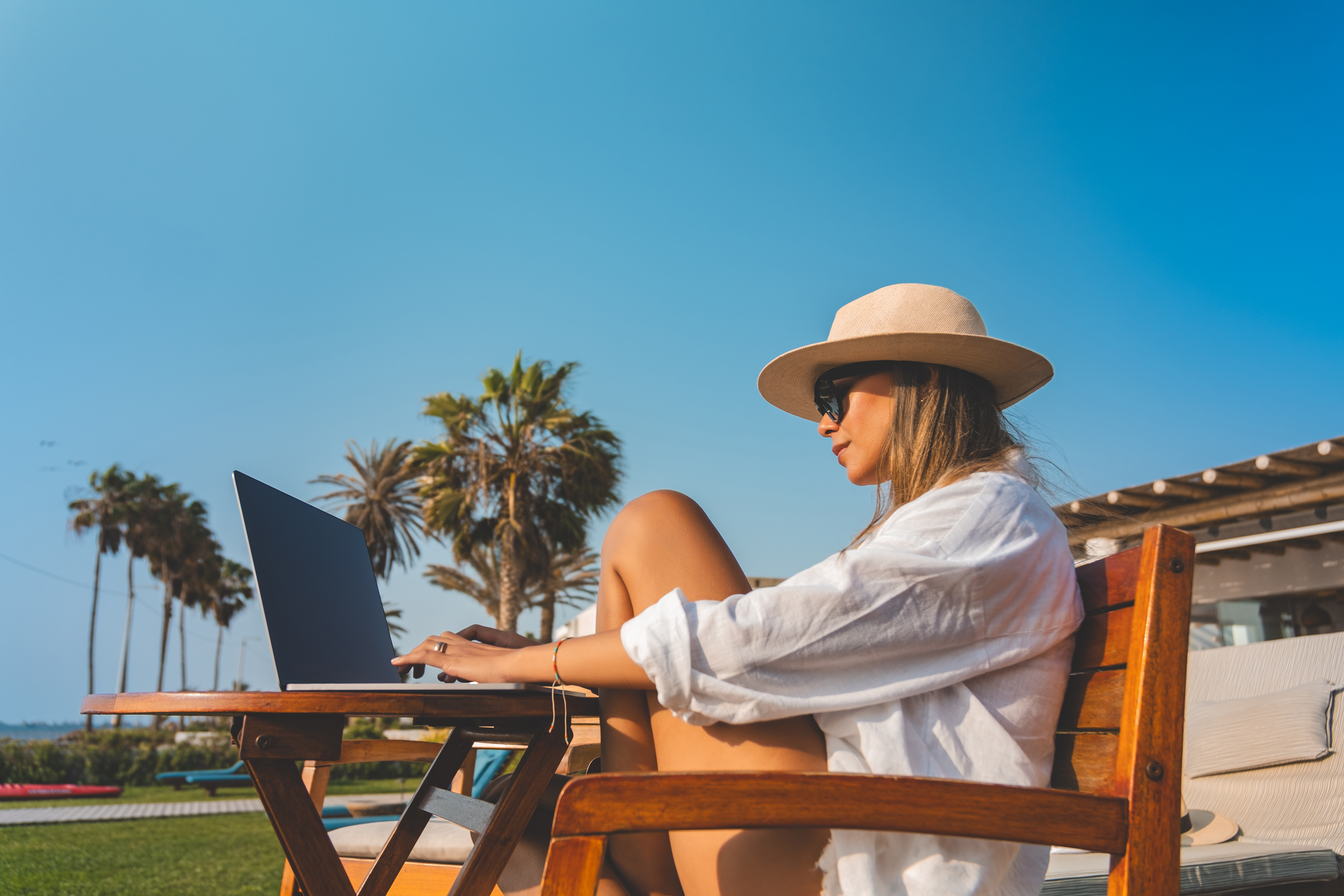 Unlocking Wellness: Travel Tips for the Busy Woman Entrepreneur 1 woman working remotely with ocean view woman is s c6bb24d72882c167bc26