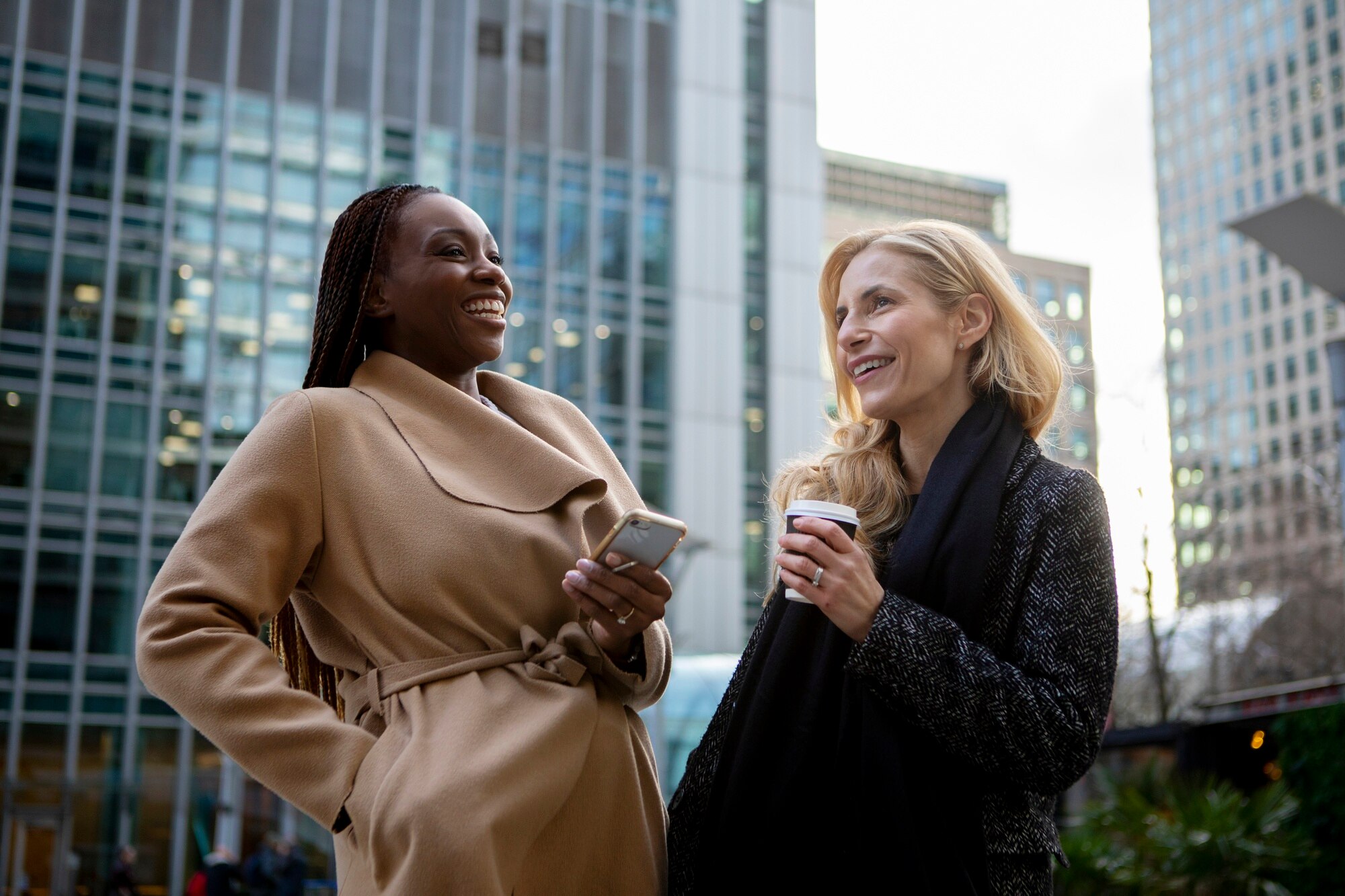 women showing her colleague something on her smart a8b70942eb5b7c1fad84 The Impact of Location-Focused Platforms on Service Quality in New York's Wellness Industry