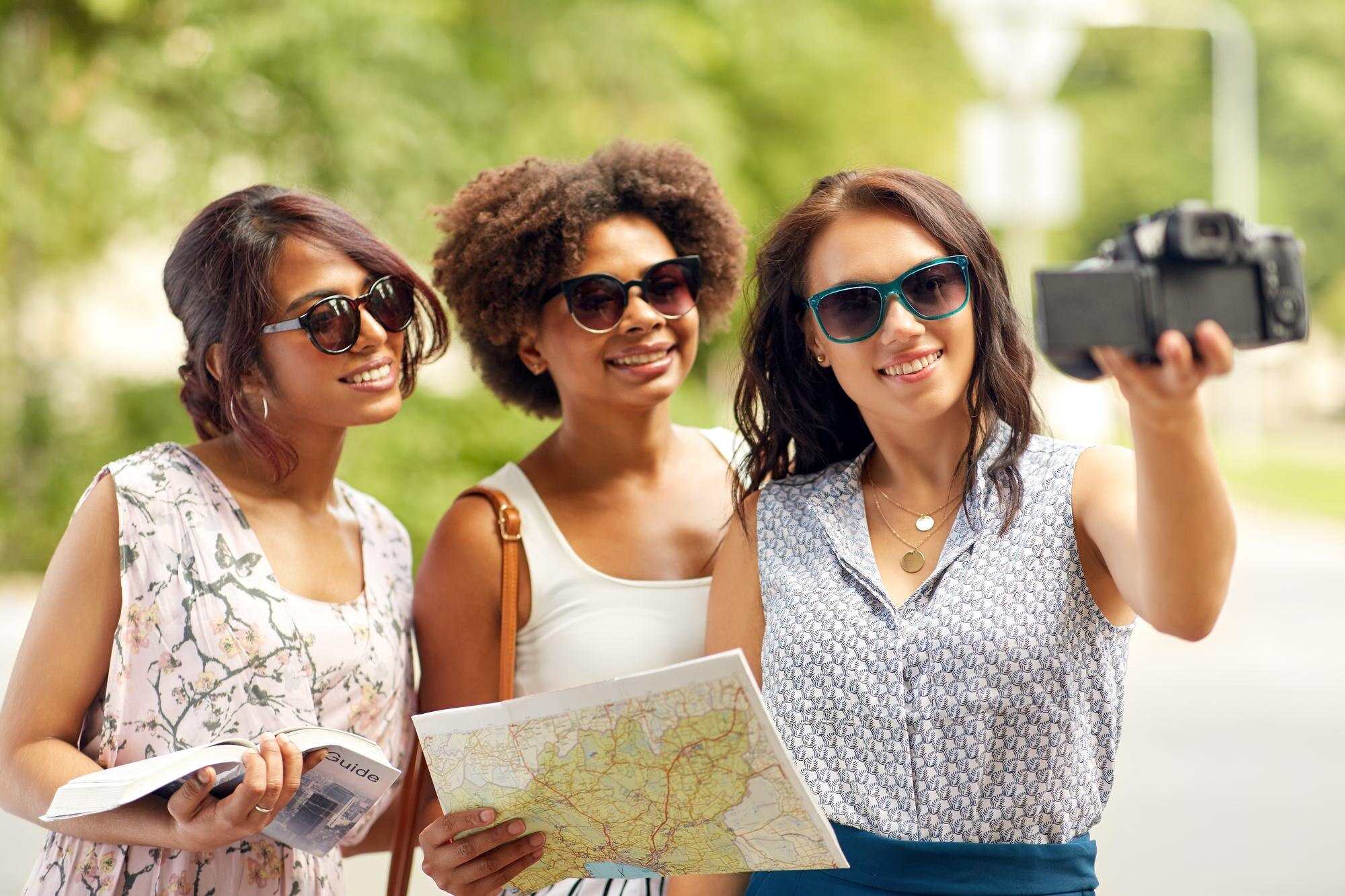women with map travelling and recording video blog ba207a00b4c4660fa63c