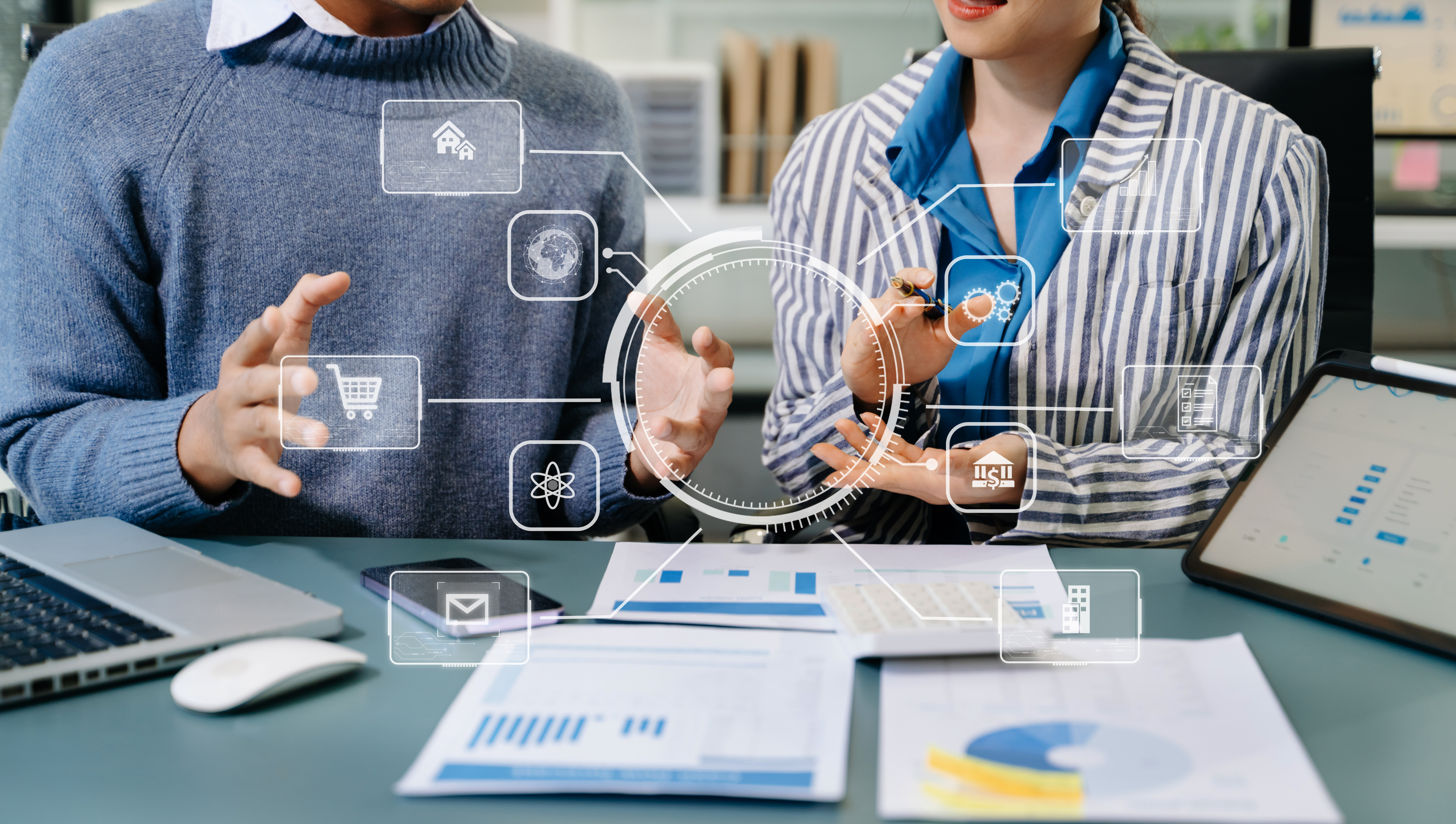 Business professionals discussing local citation strategies with digital icons representing online visibility, analytics, and communication on a laptop and documents.