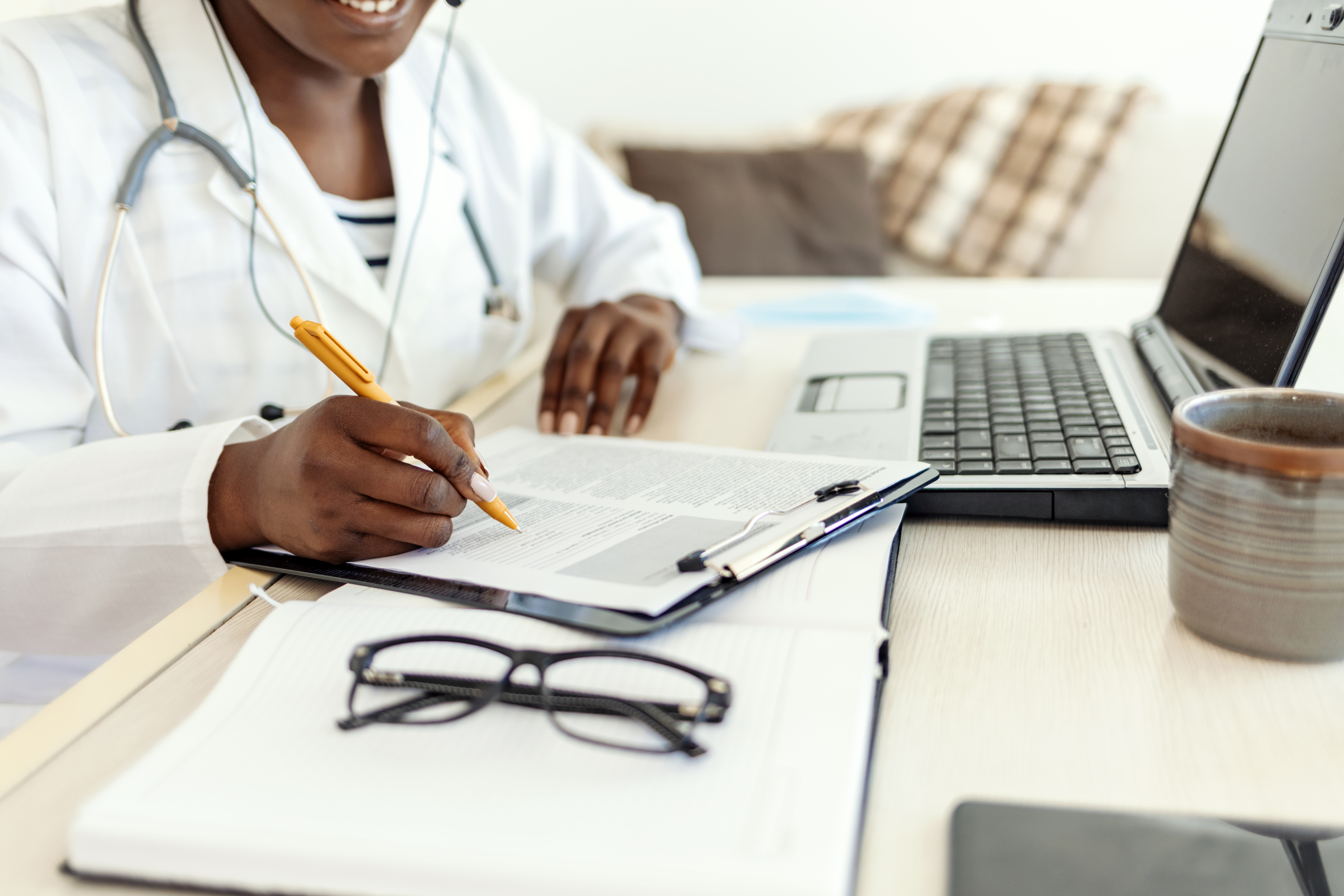Mastering The Oet Writing Subtest: Essential Strategies Using Medical Letter Templates 1 image of a health worker writing - an illustration of the medical letter correction service by Accordemy®