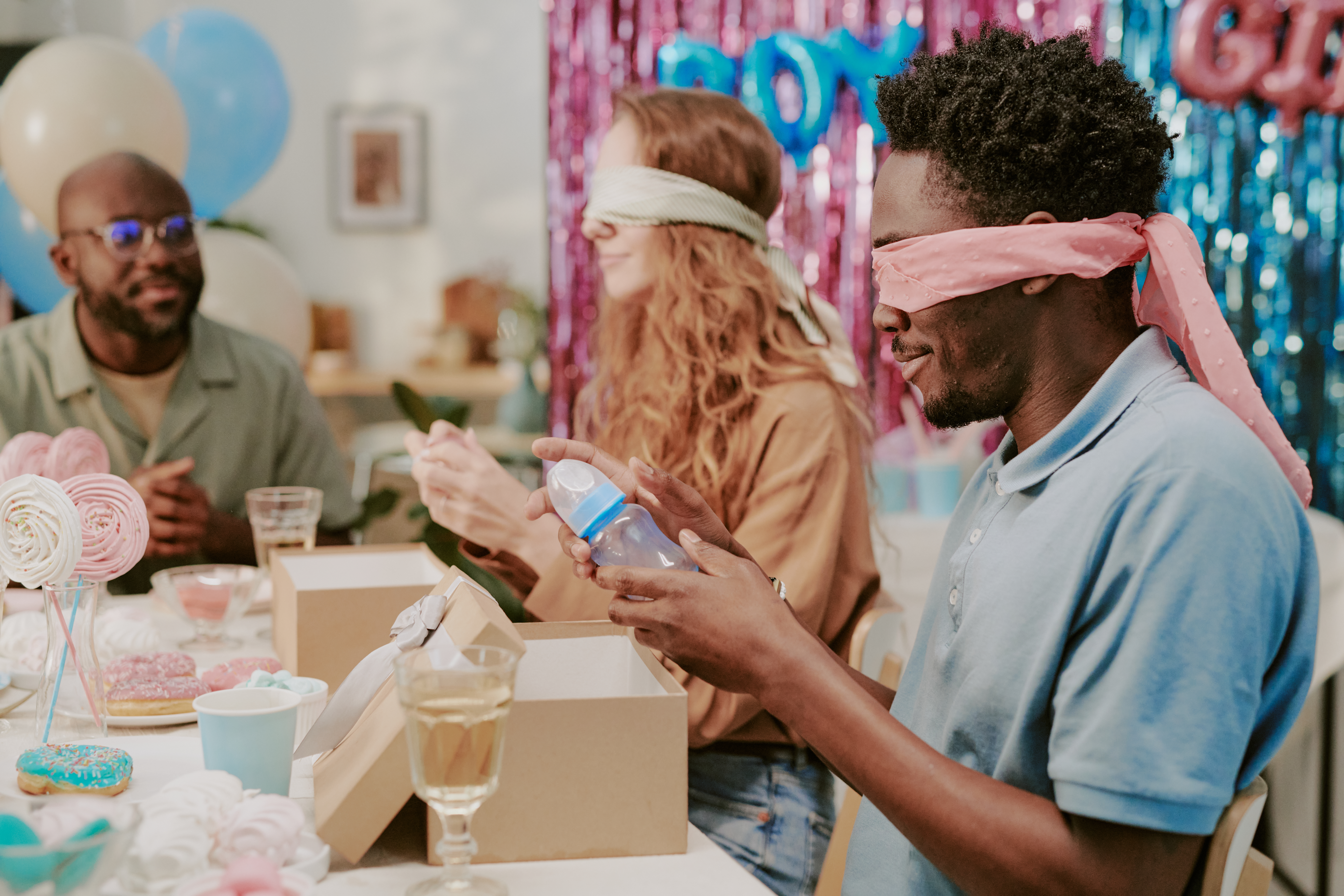 coed couple opening baby shower gifts