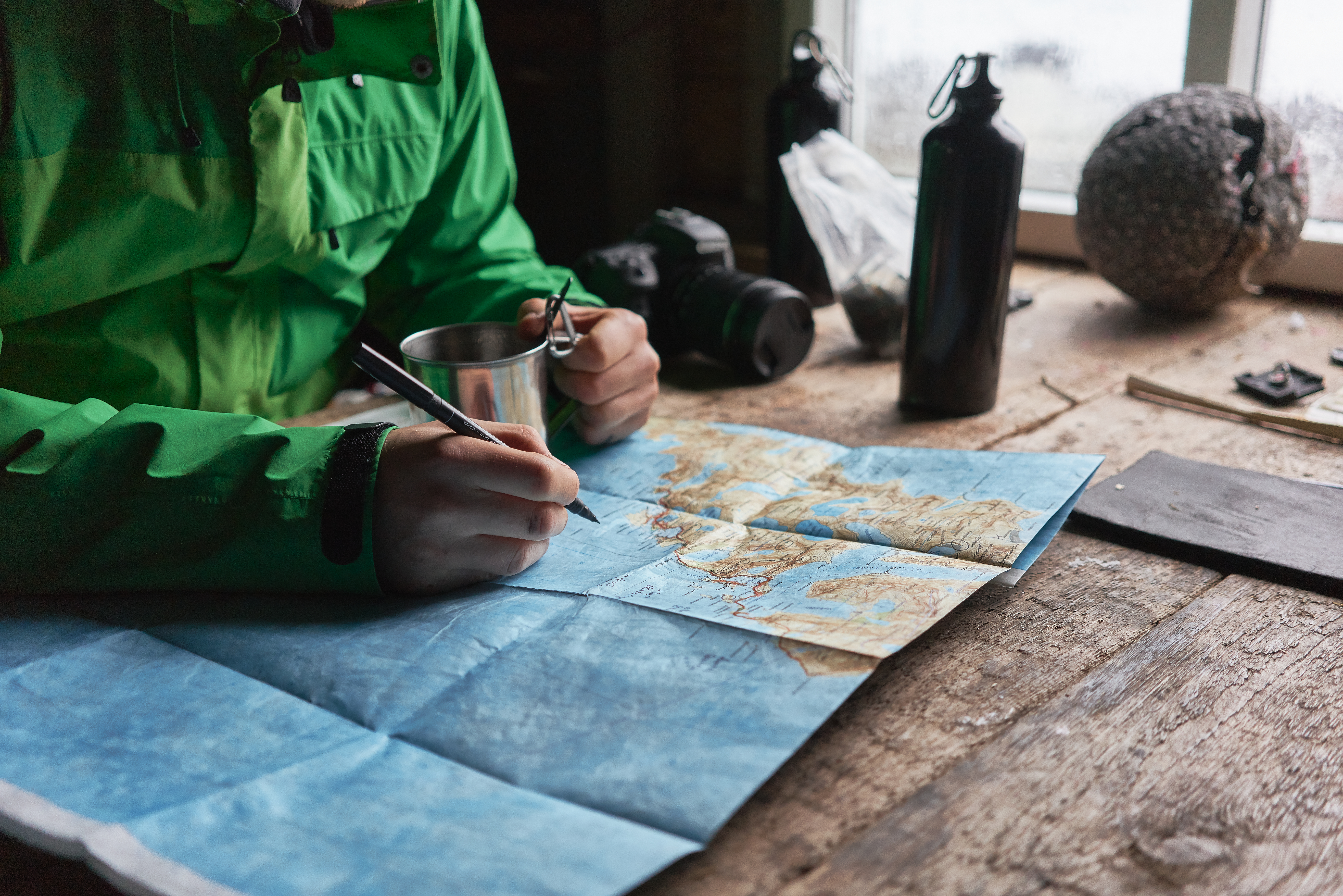 Traveler studying a map as a keepsake to remember their outdoor adventure