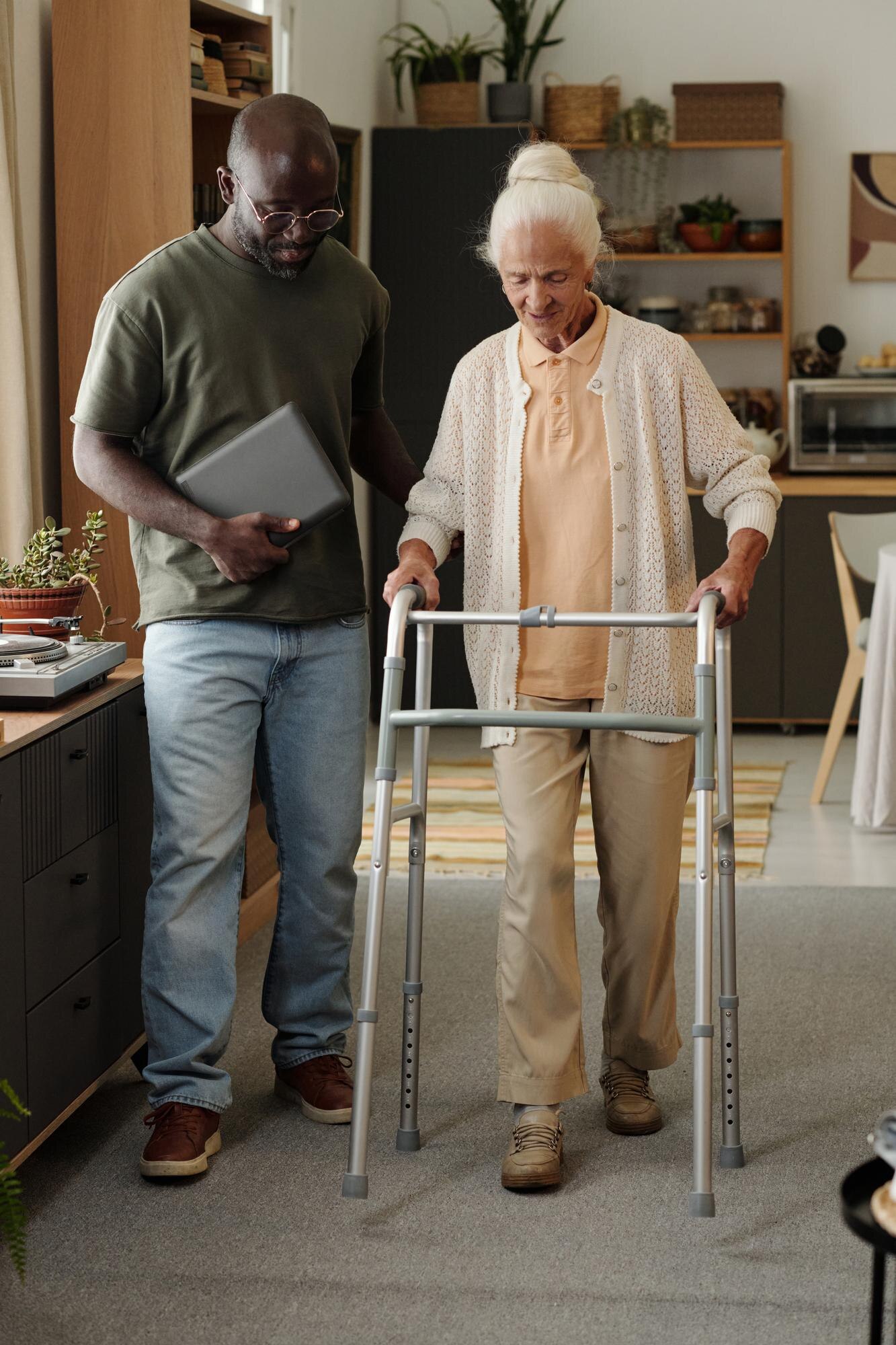 young black man assisting senior caucasian woman u 6ba6b1a7cd0552d3361a