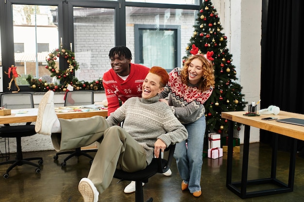 young coworkers joyfully celebrating christmas at 42532d229539b83f1626